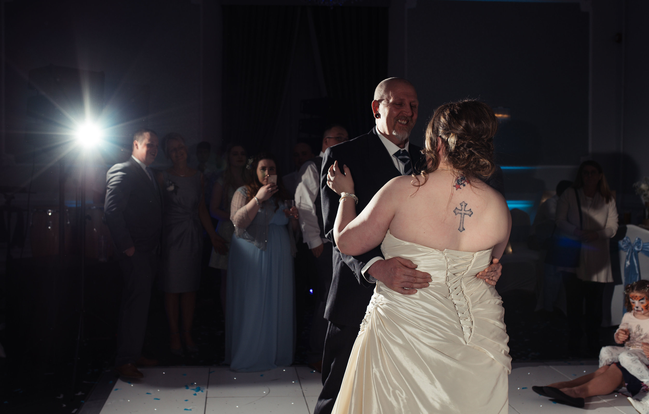 The bride has a dance with her father during the evening wedding reception