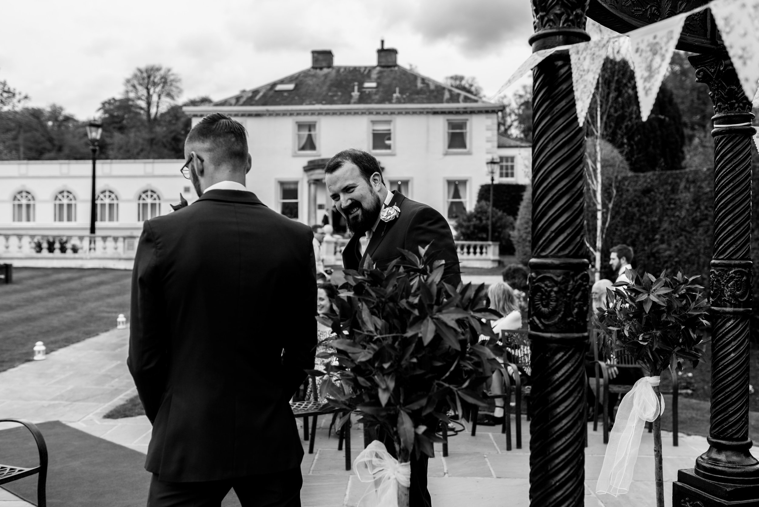 The groom and the best man share a joke together before the wedding ceremony starts