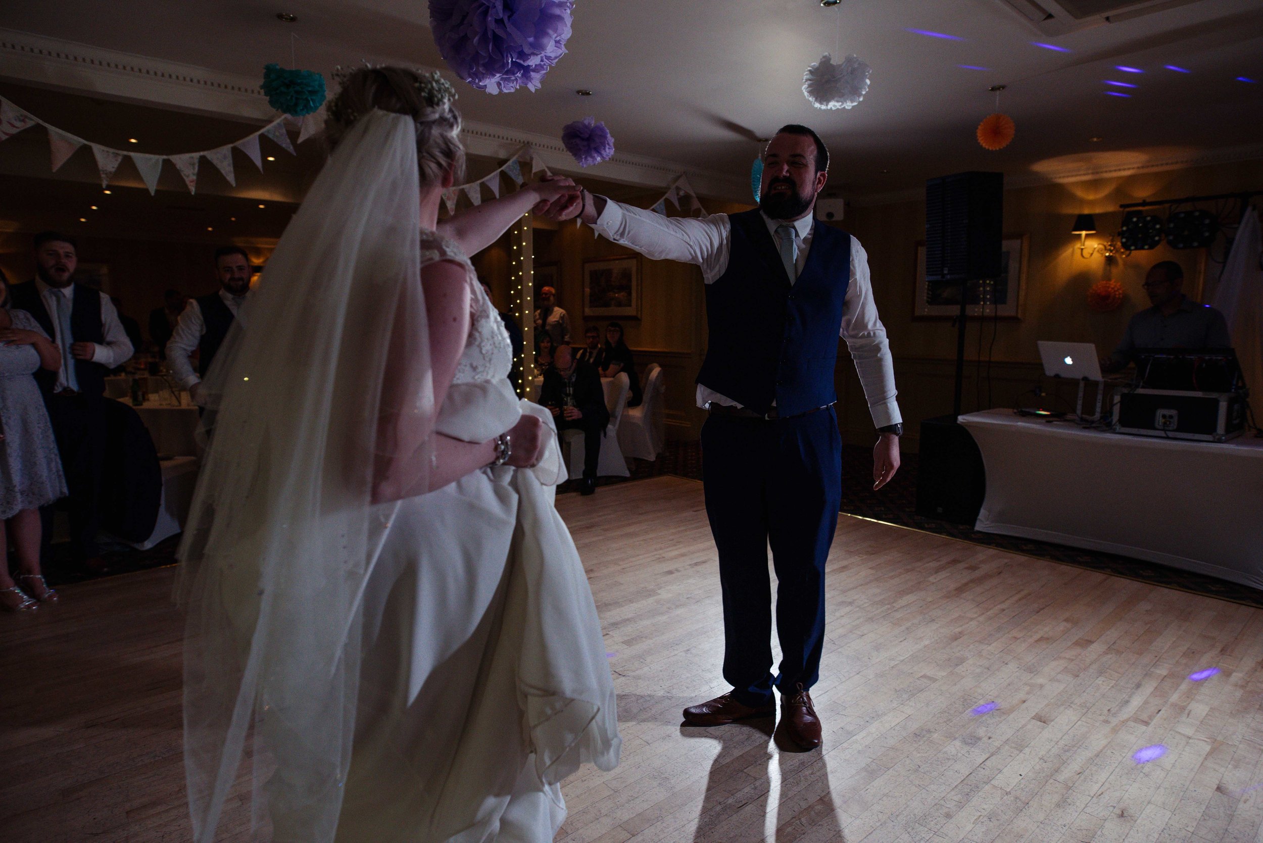 The groom is visible during the bride and grooms first dance together