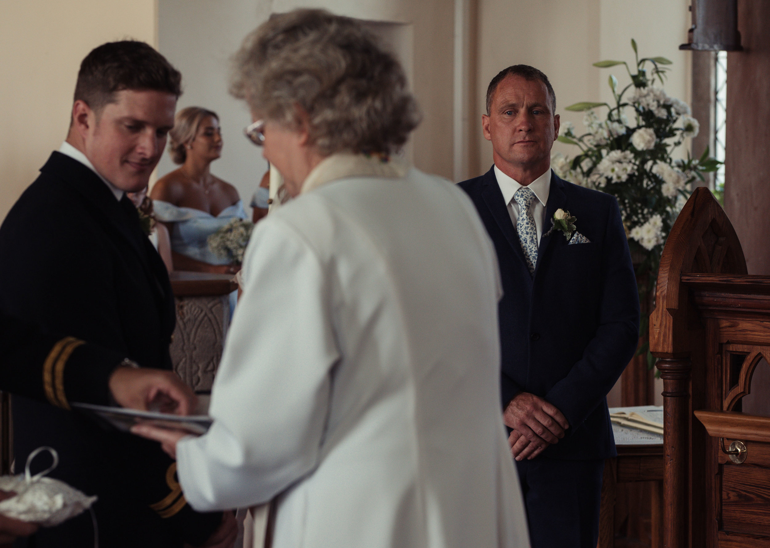 the father of the bride has tears in his eyes as rings are exchanged