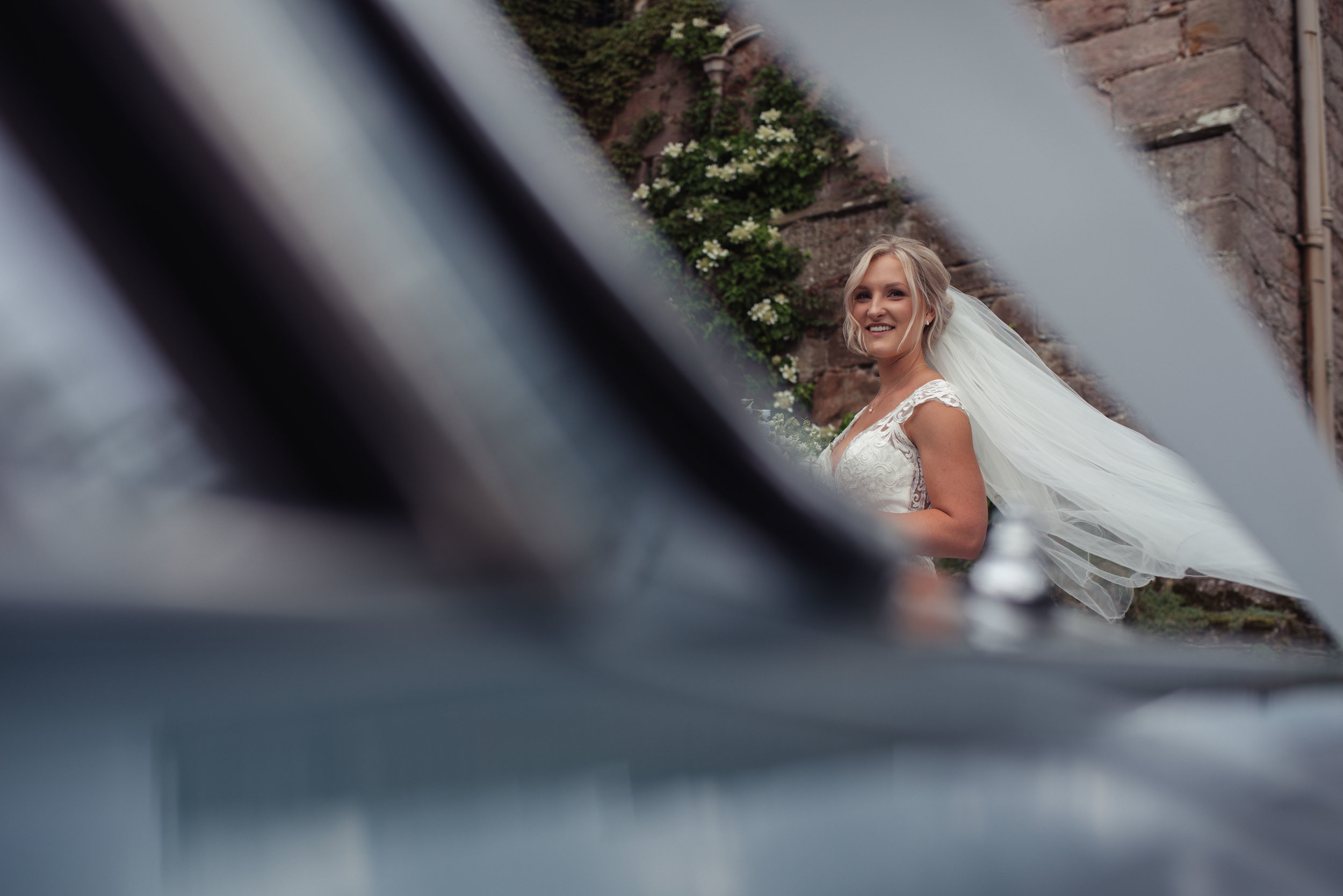 the bride looks at guests walking into the reception at askham hall
