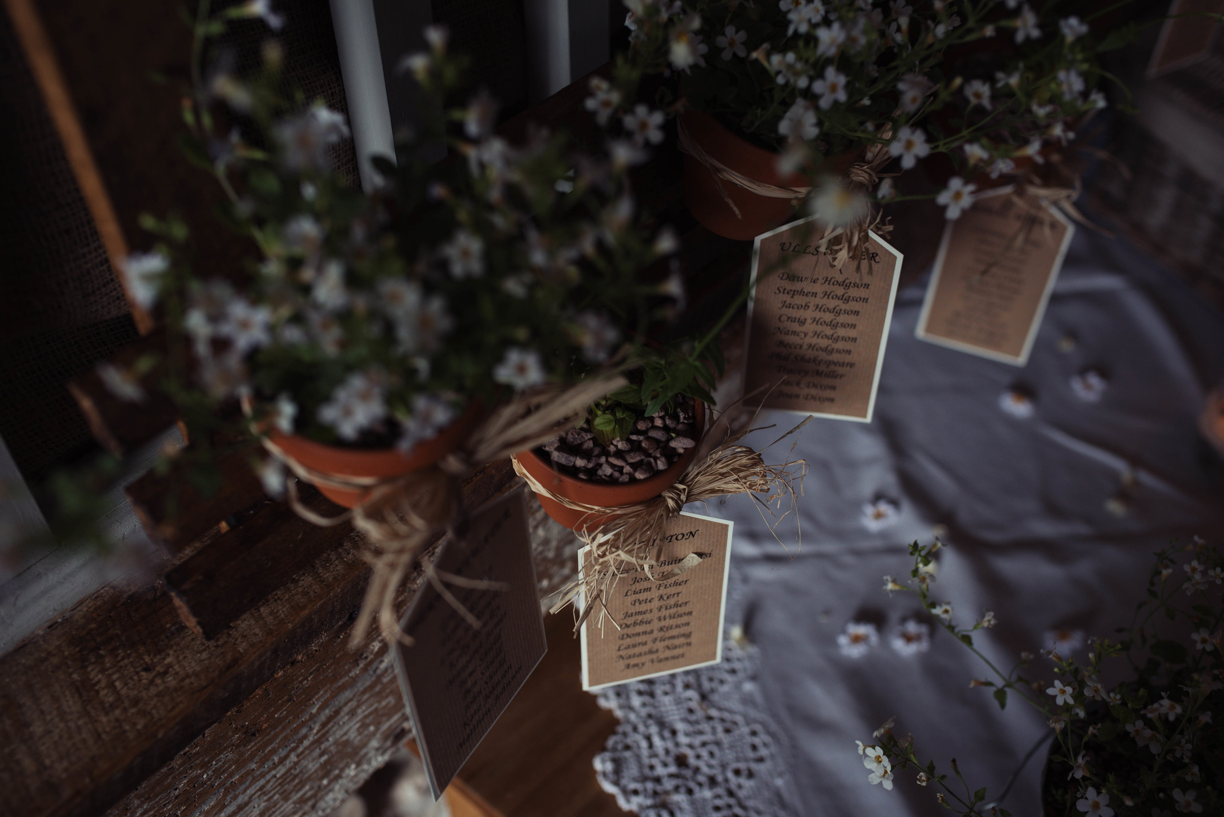 Rustic and bushy table decorations in the barn at Askham Hall