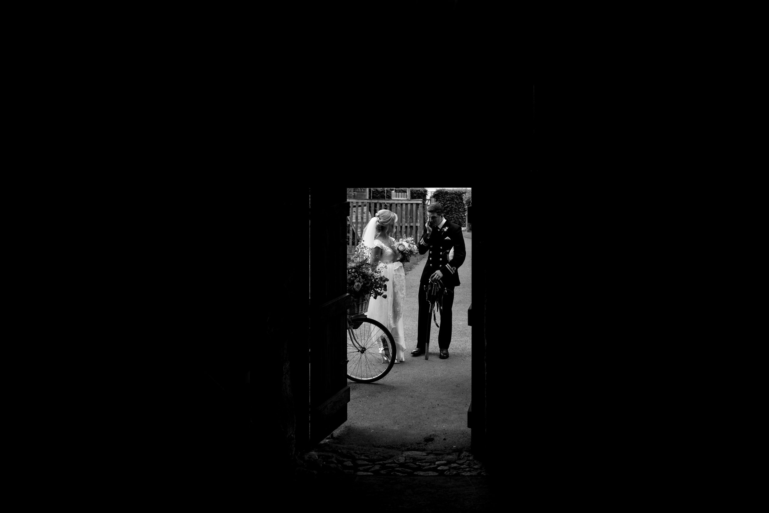 The bride and groom at Askham Hall wait to be ushered into the barn for their wedding breakfast