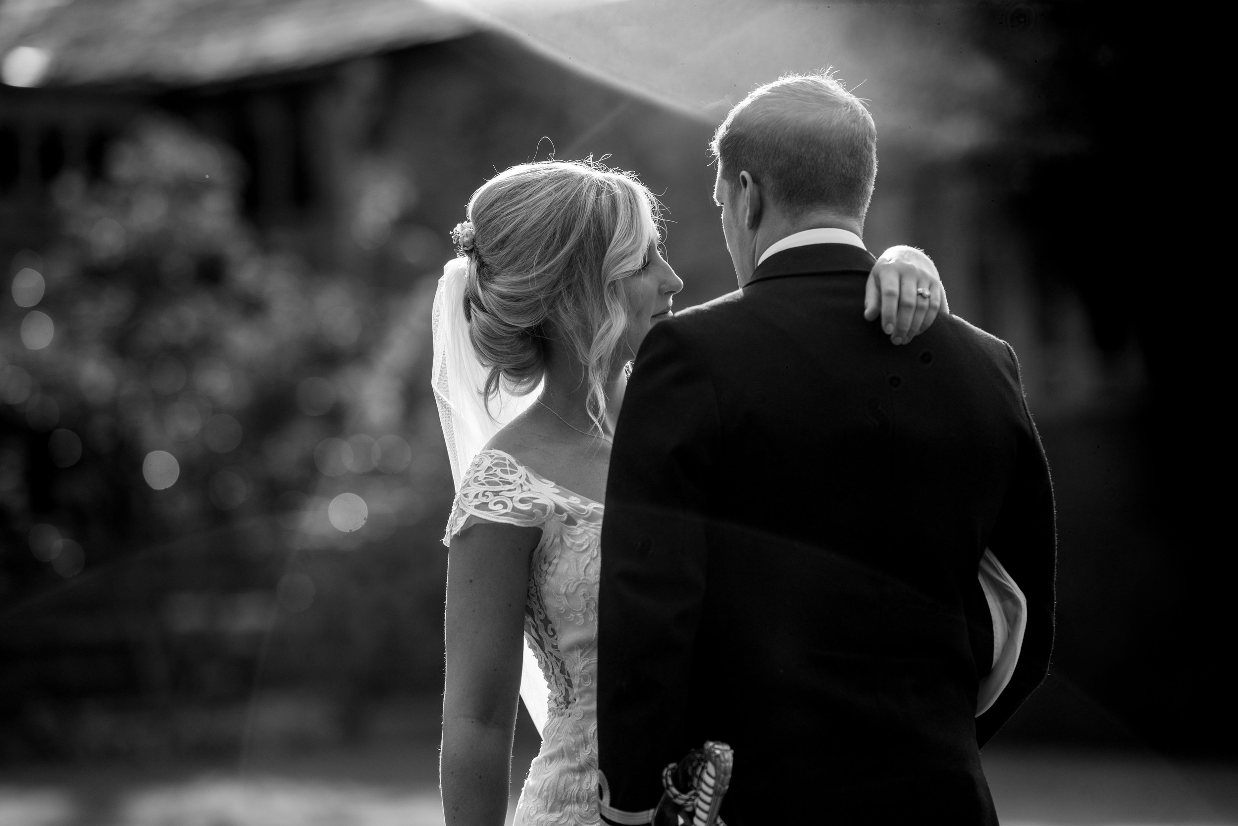 Beautiful sunset shrouds the bride and groom in watery evening light at Askham Hall