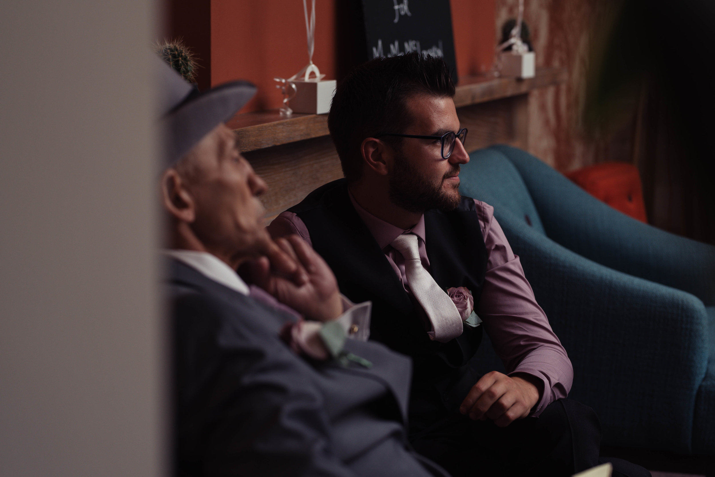 The best man sits next to the groom in the bar