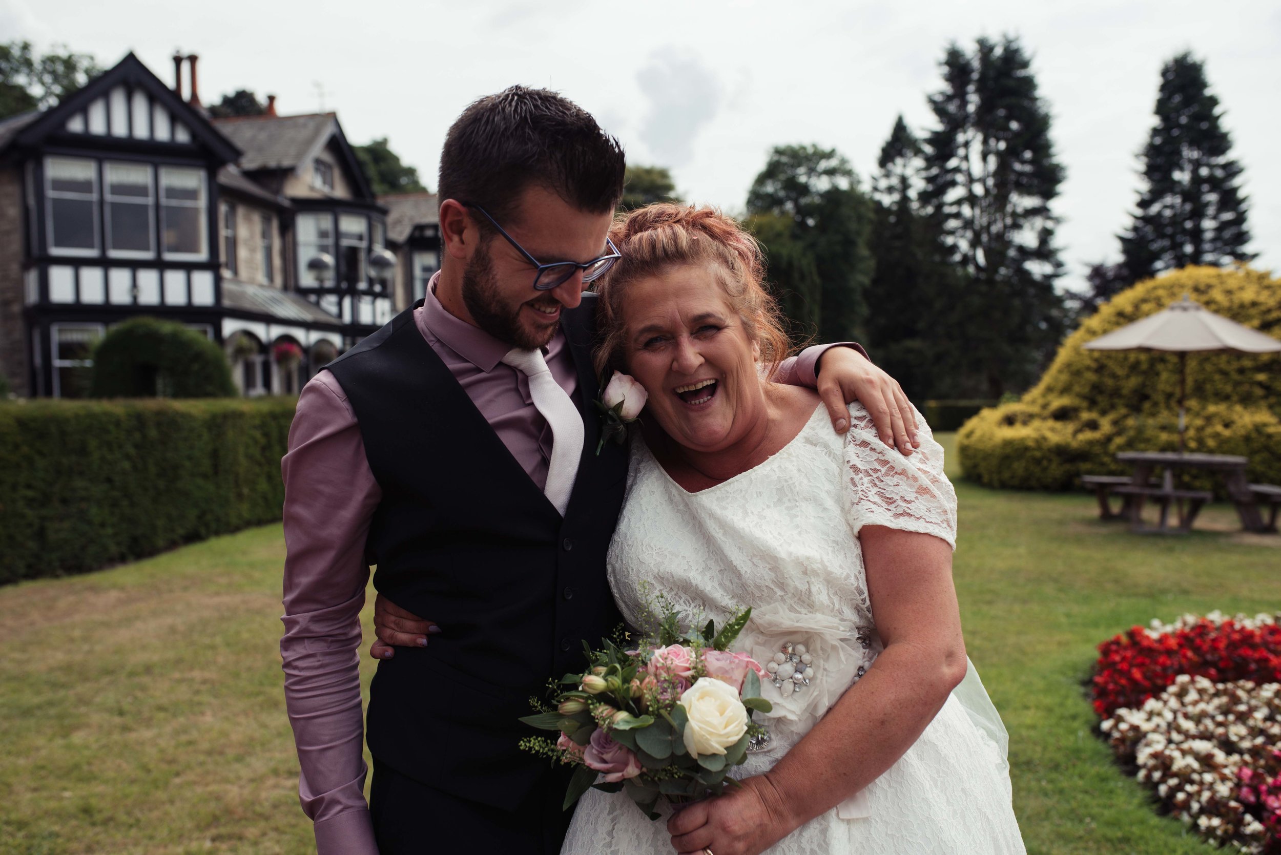 The best man makes the bride laugh in the grounds of the castle green hotel