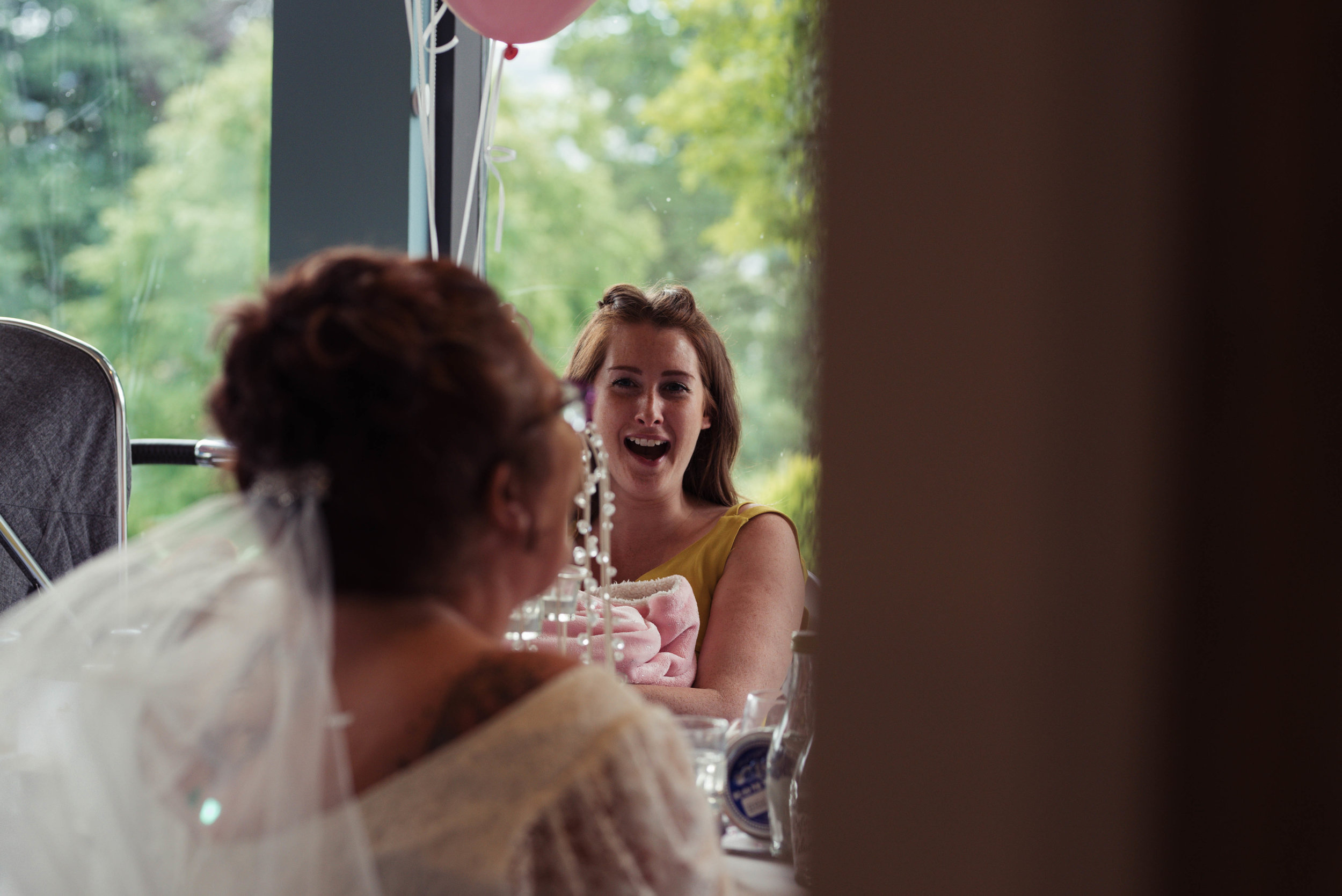 The best mans wife laughs at one of her husbands jokes