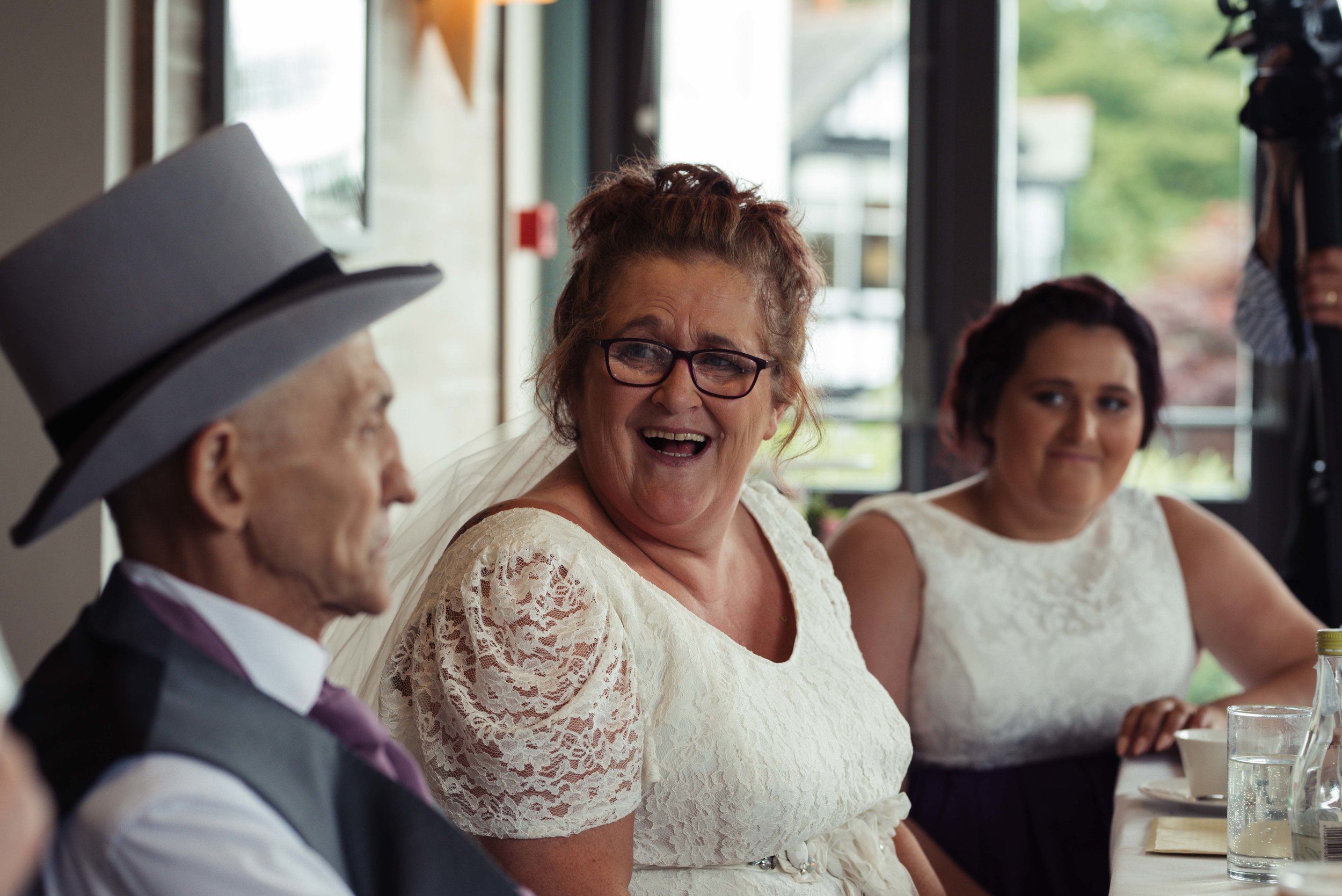 The bride looks to her new husband and laughs her head off