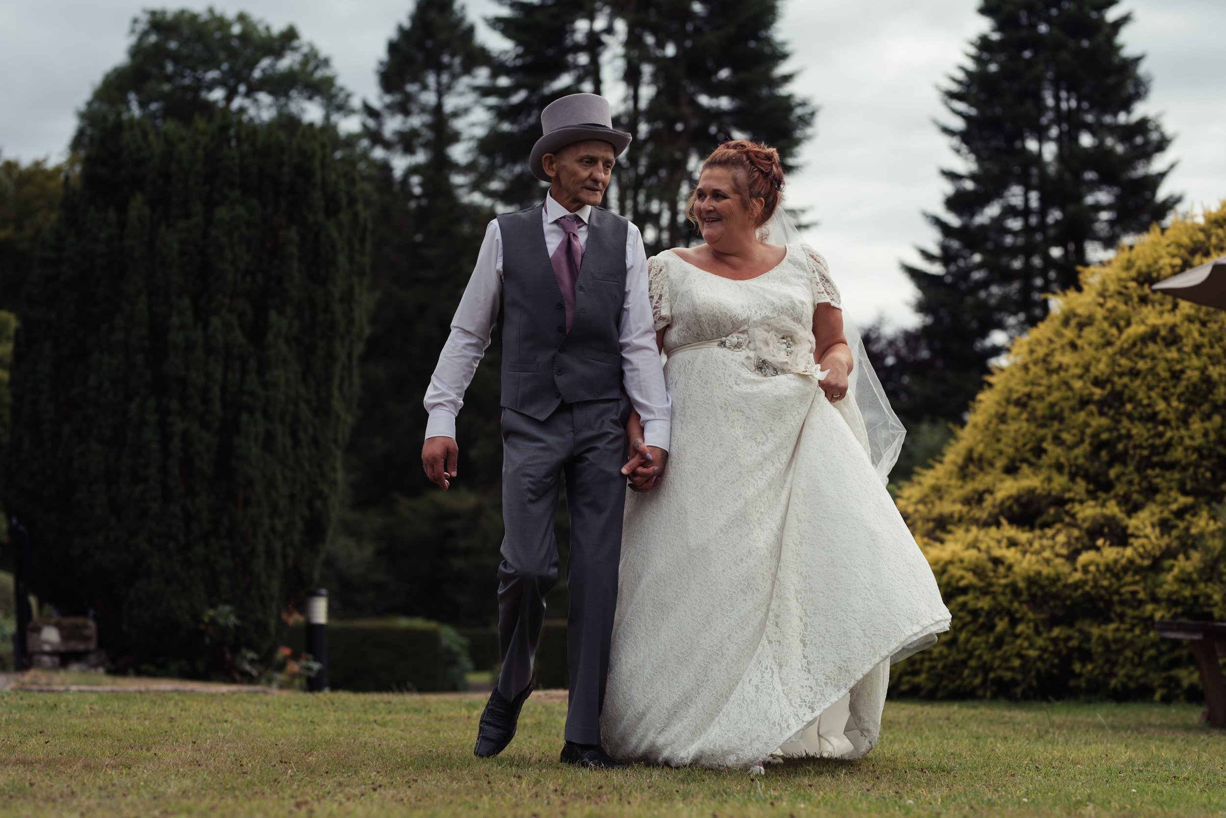 The bride and groom walk together during their lake district wedding photography portrait session