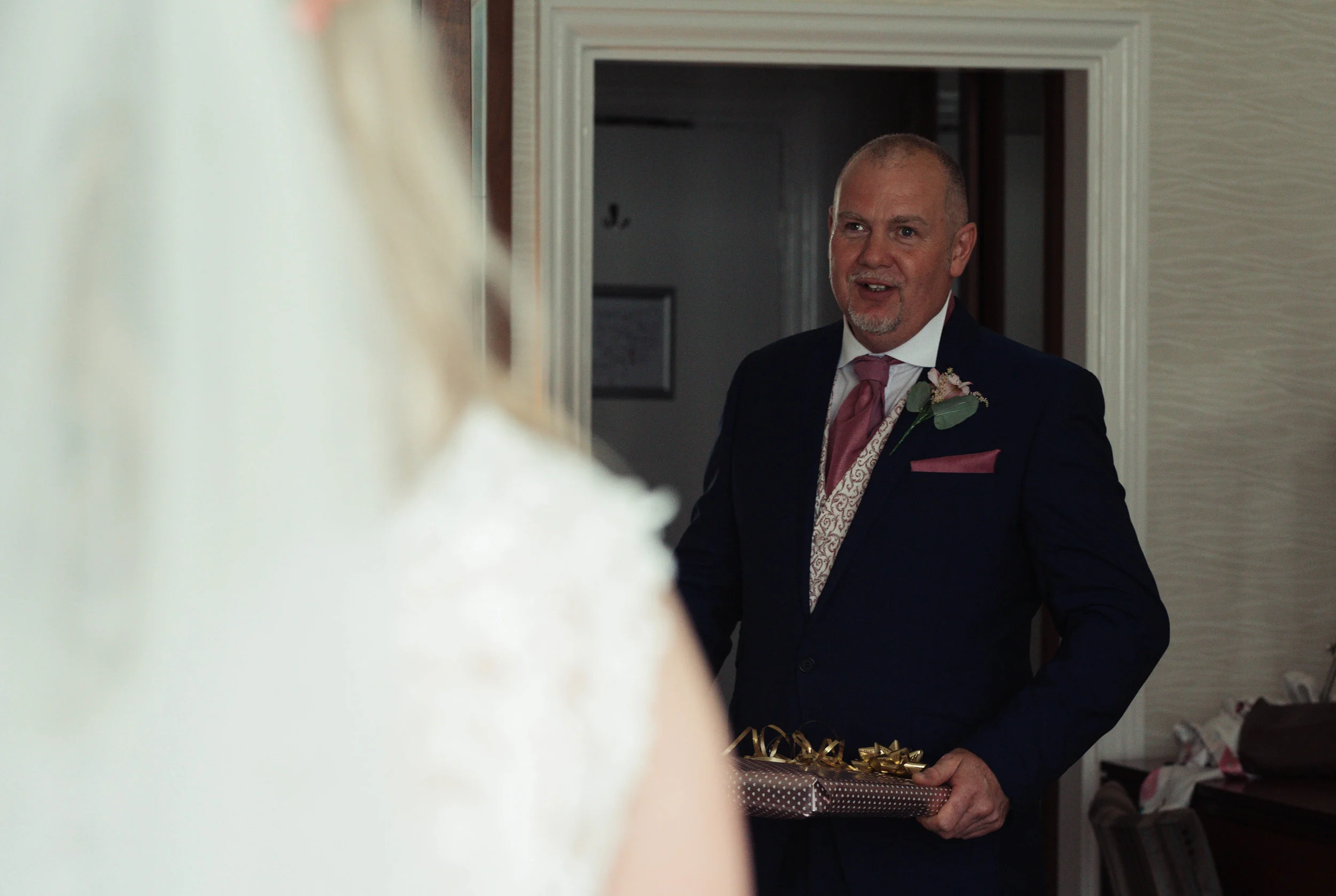 Father of the bride sees his daughter for the first time in a wedding dress