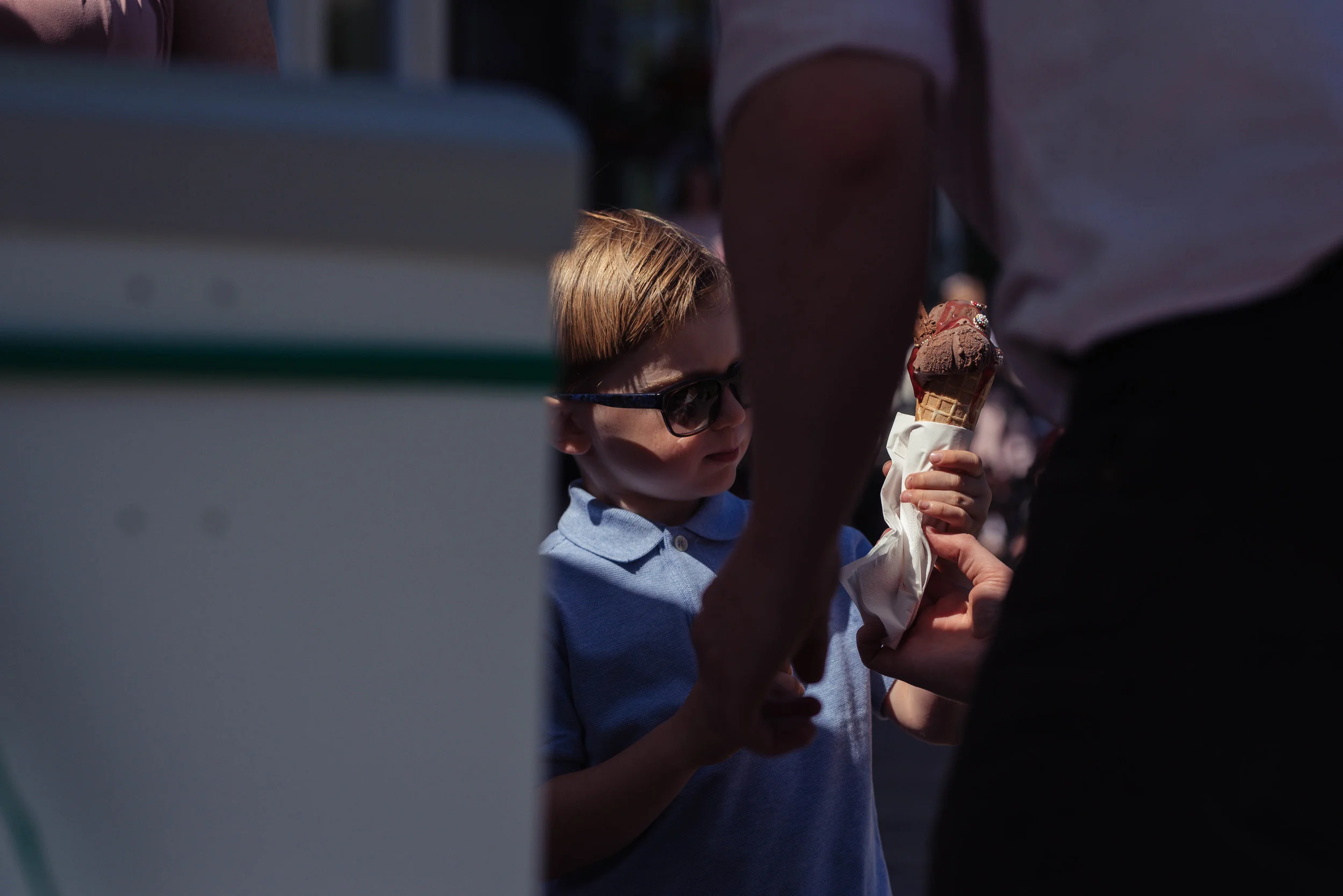 A young boy guest gets an ice cream at the wedding reception