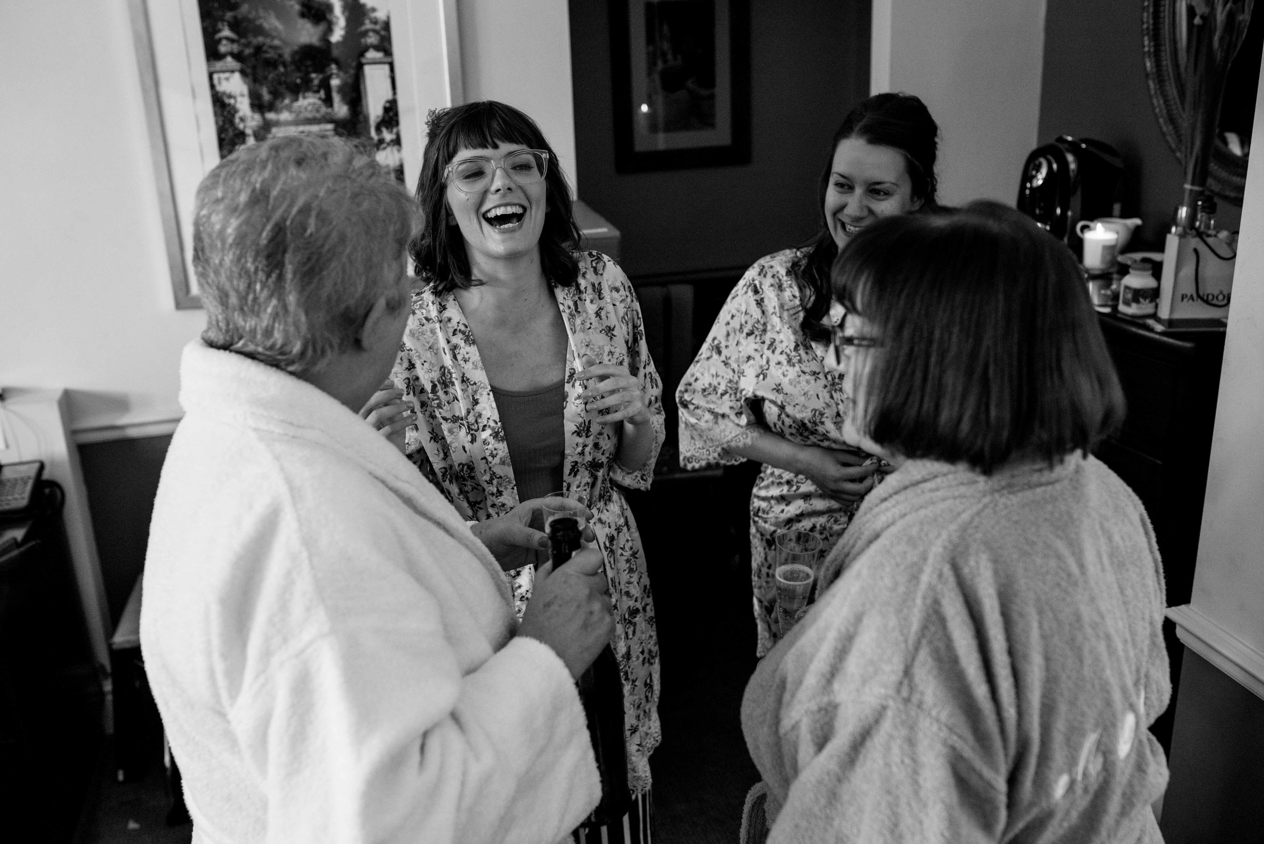 Bridemaids stand around in the room before the wedding 