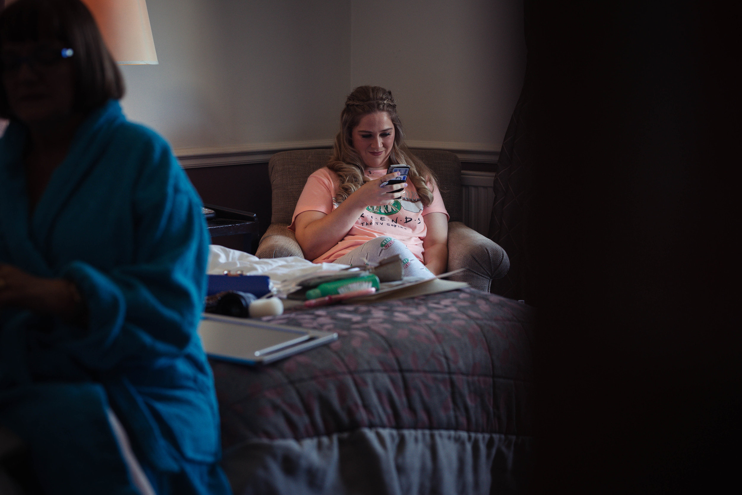 A bridesmaid sits with her baby