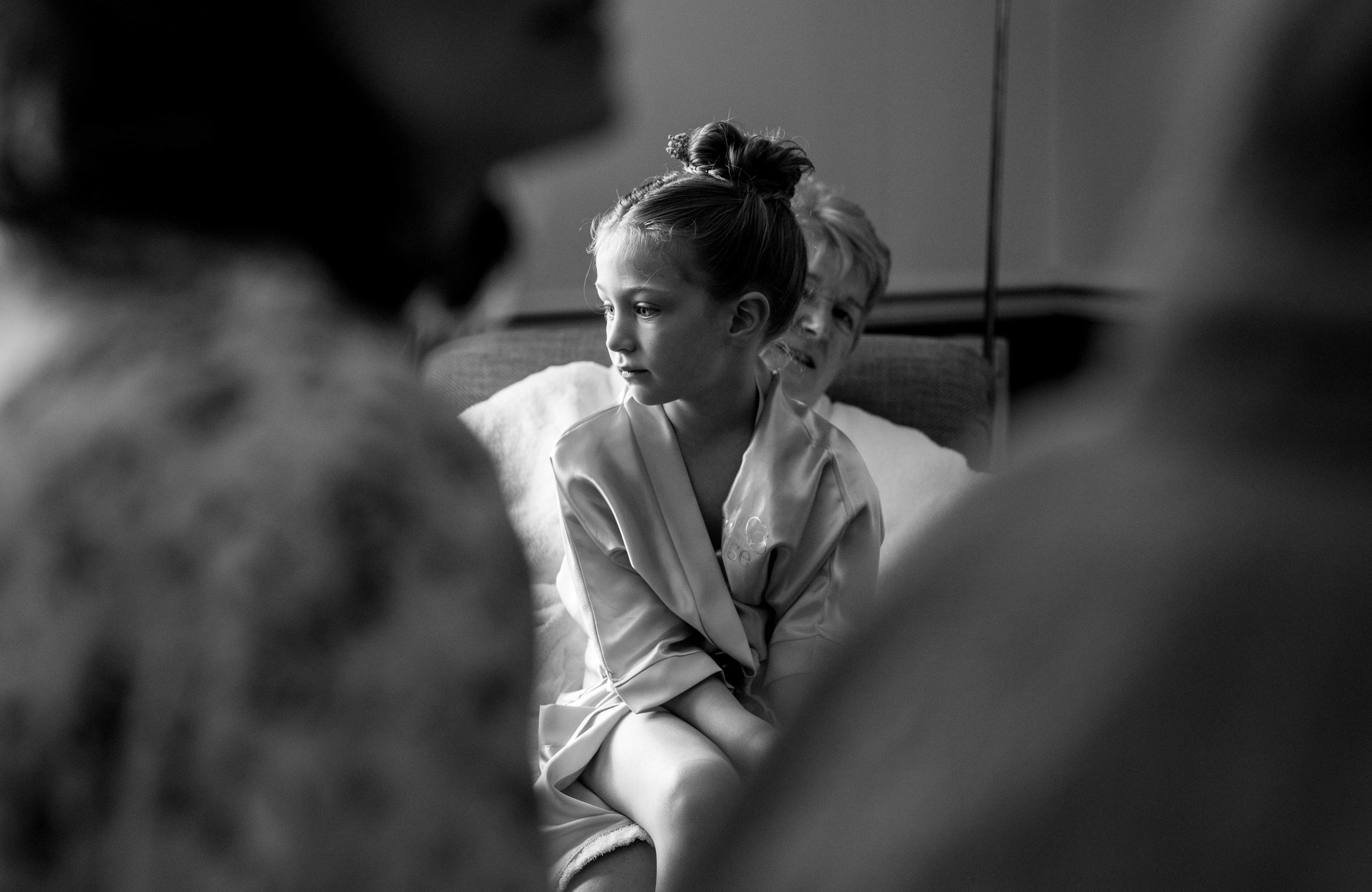 A flower girl sits and contemplates