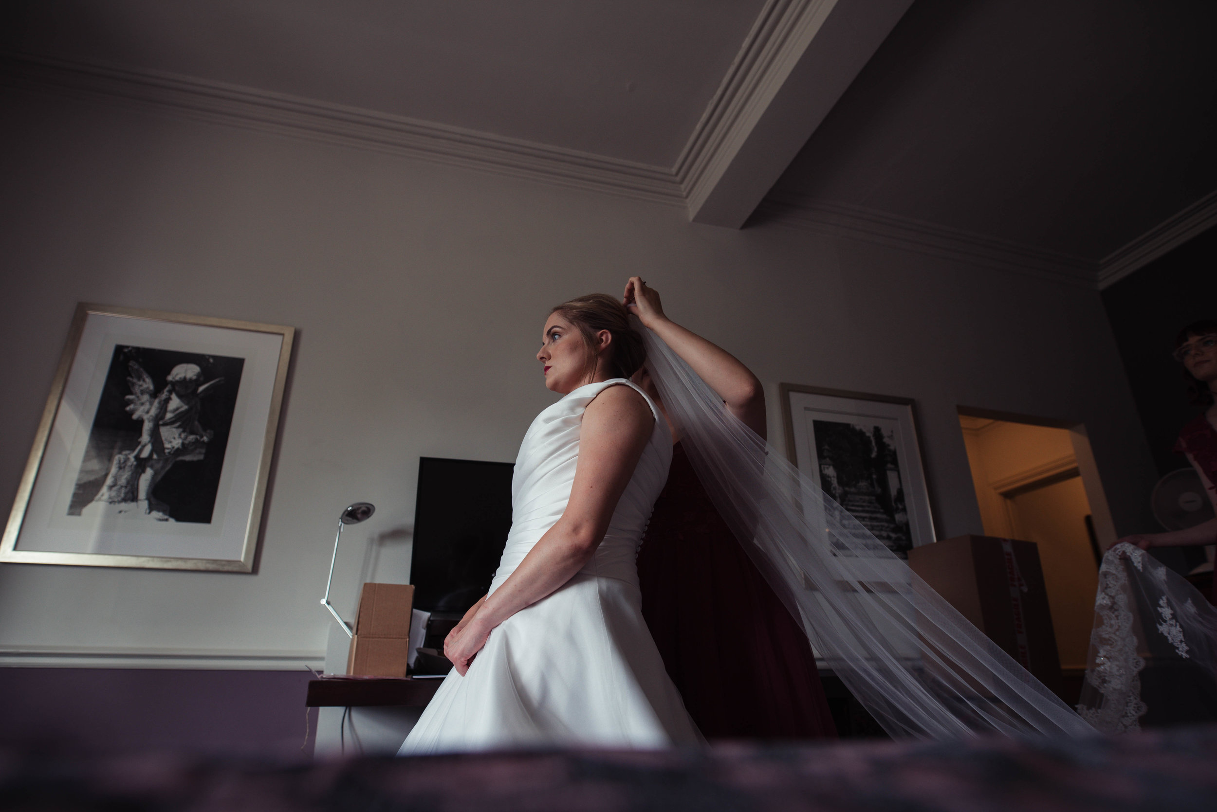 The bride gets her veil put in