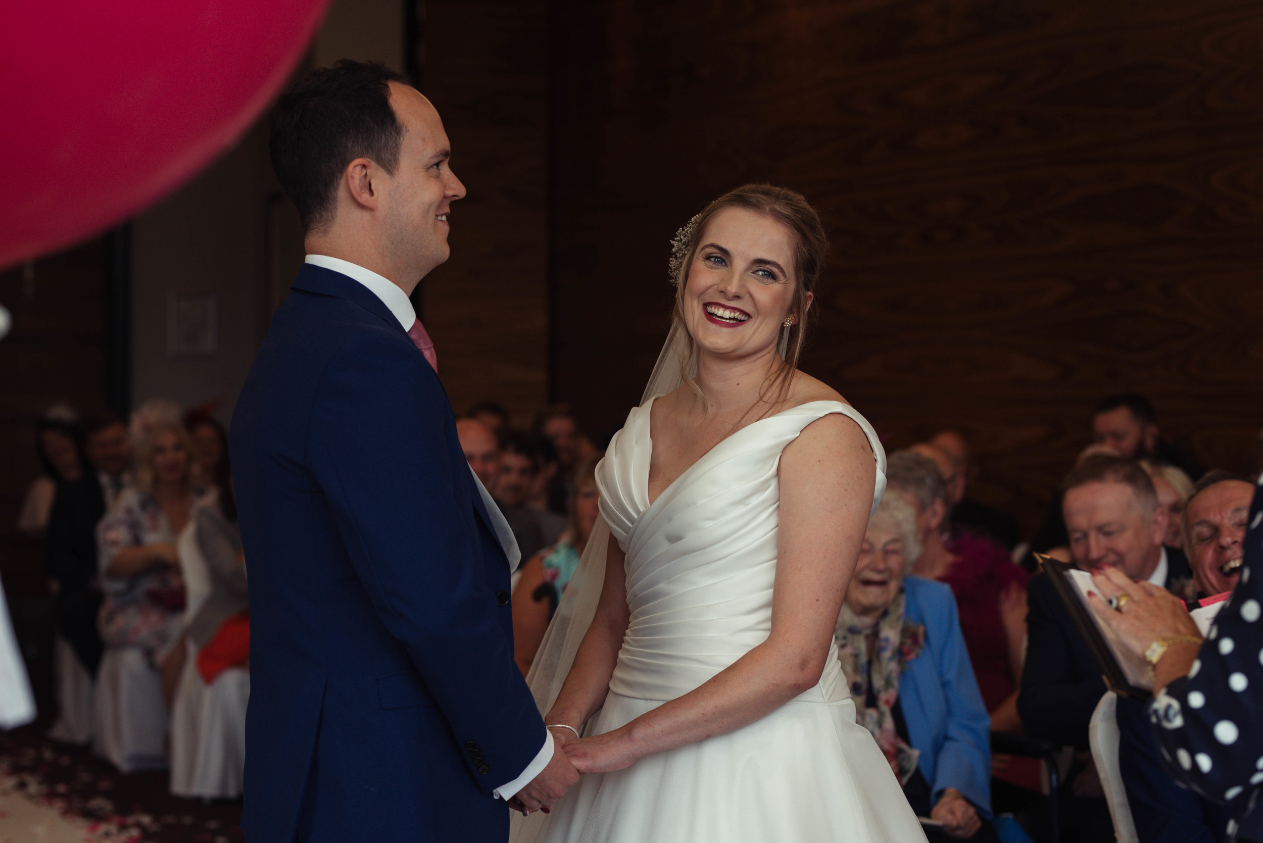 The bride and groom have a giggle together during the wedding ceremony