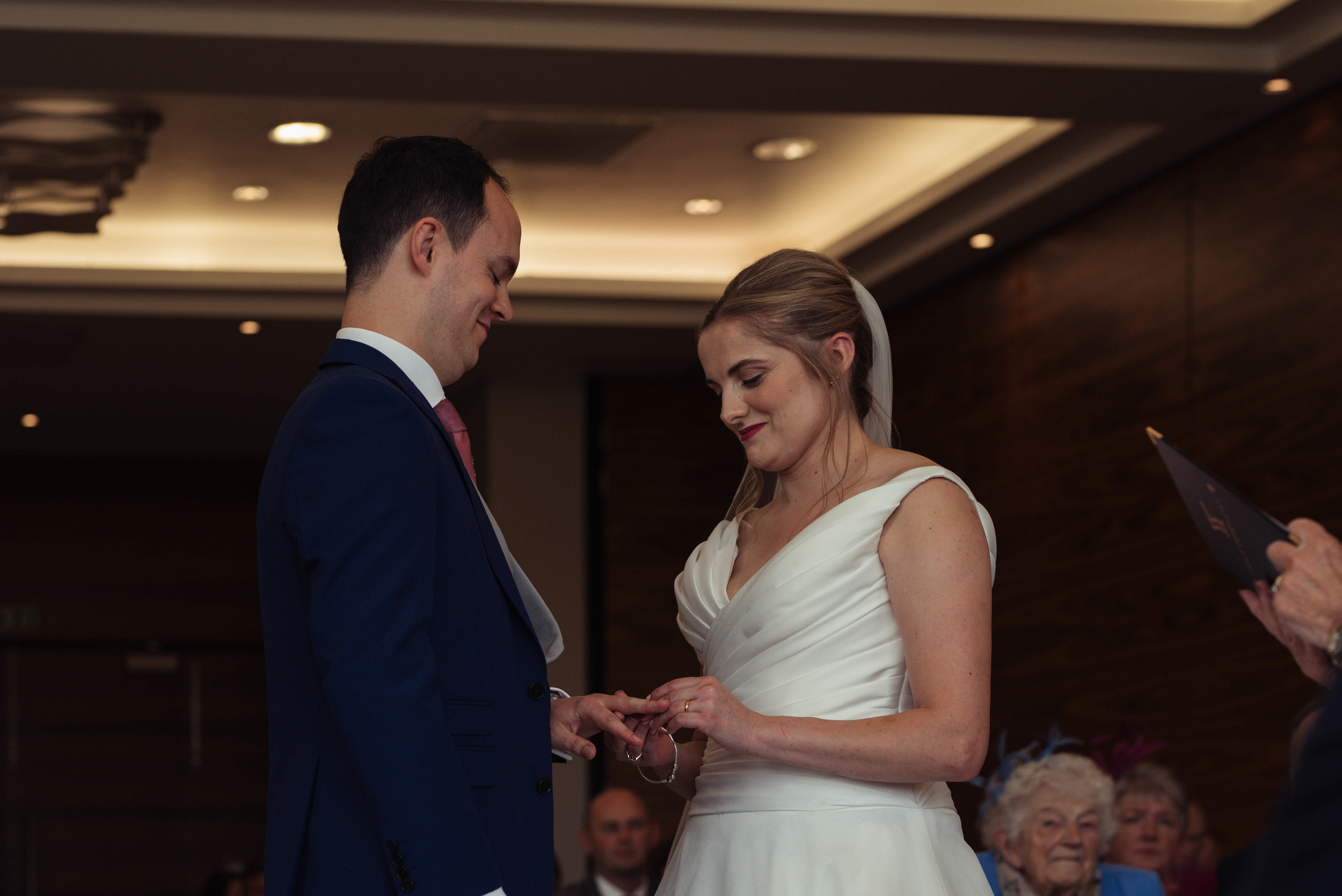 The bride and groom exchange their rings