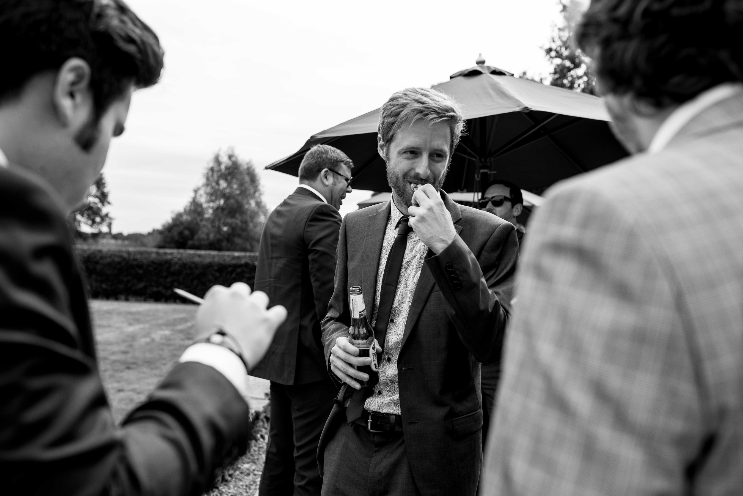 A guest bites into one of the canopes during the welcome drinks