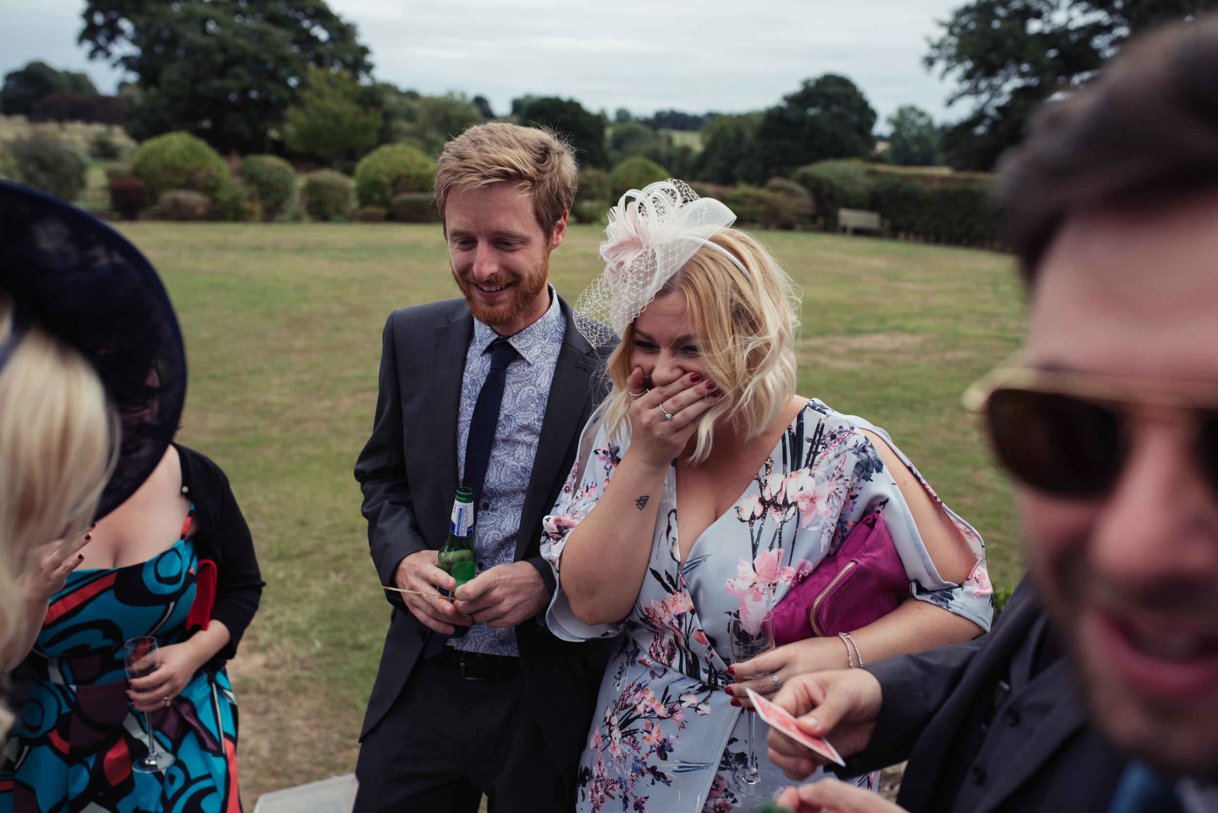 A wedding guest laughing her head off
