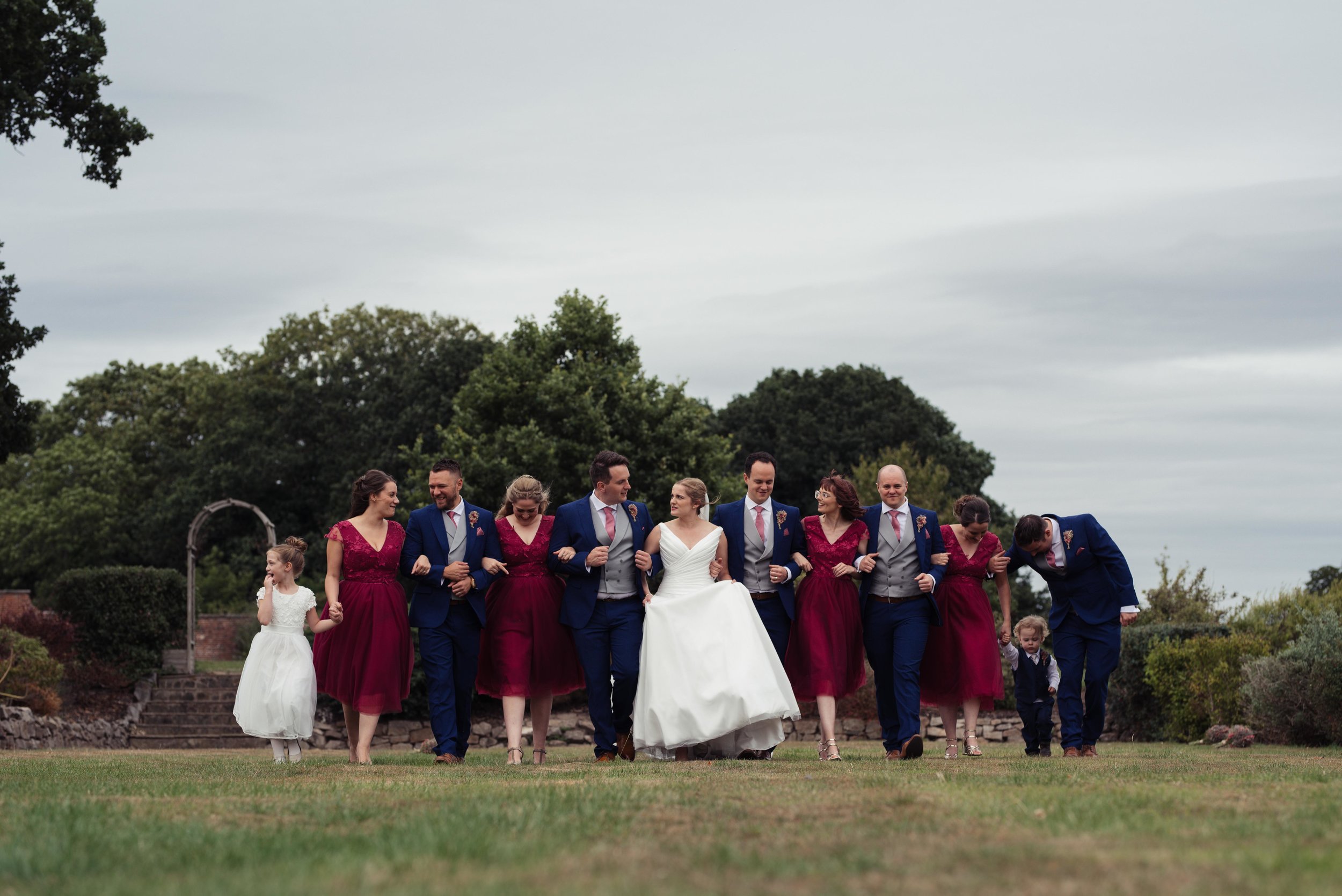 The wedding party walking towards the camera