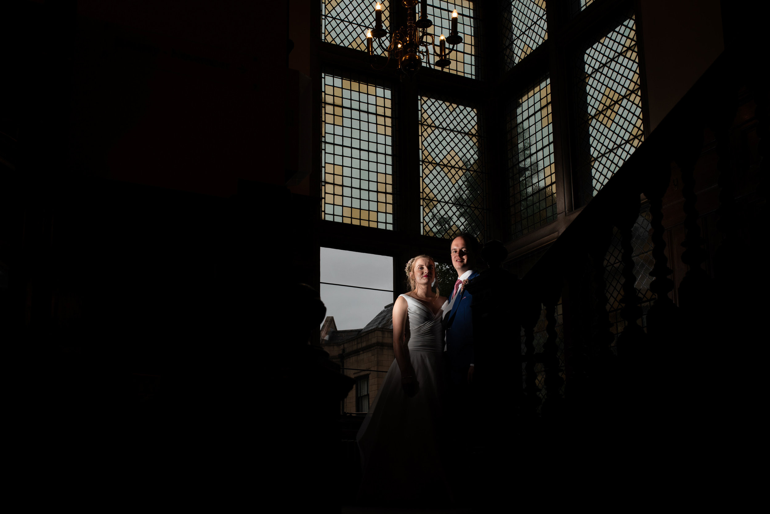Bride and groom lit up with a flash inside rookery hall