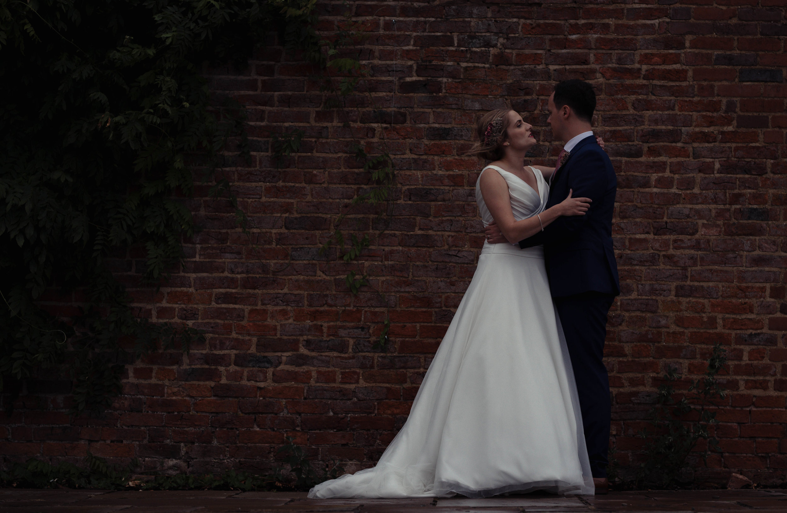 The wedding couple hug each other during the photography