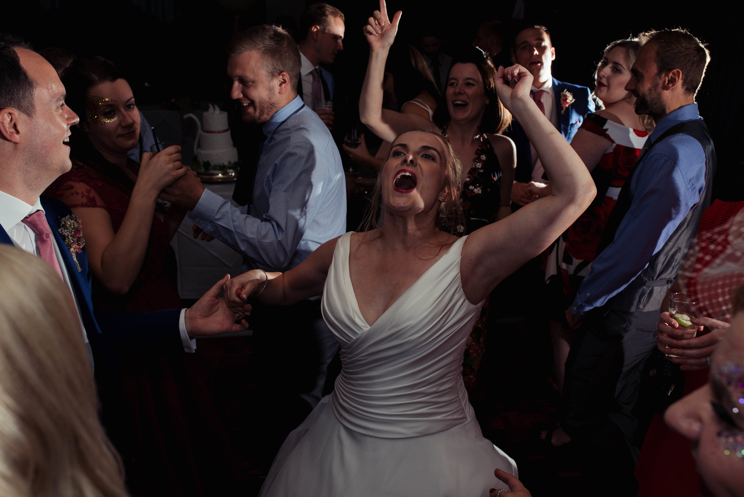 The bride letting her hair down with her friends on the dance floor
