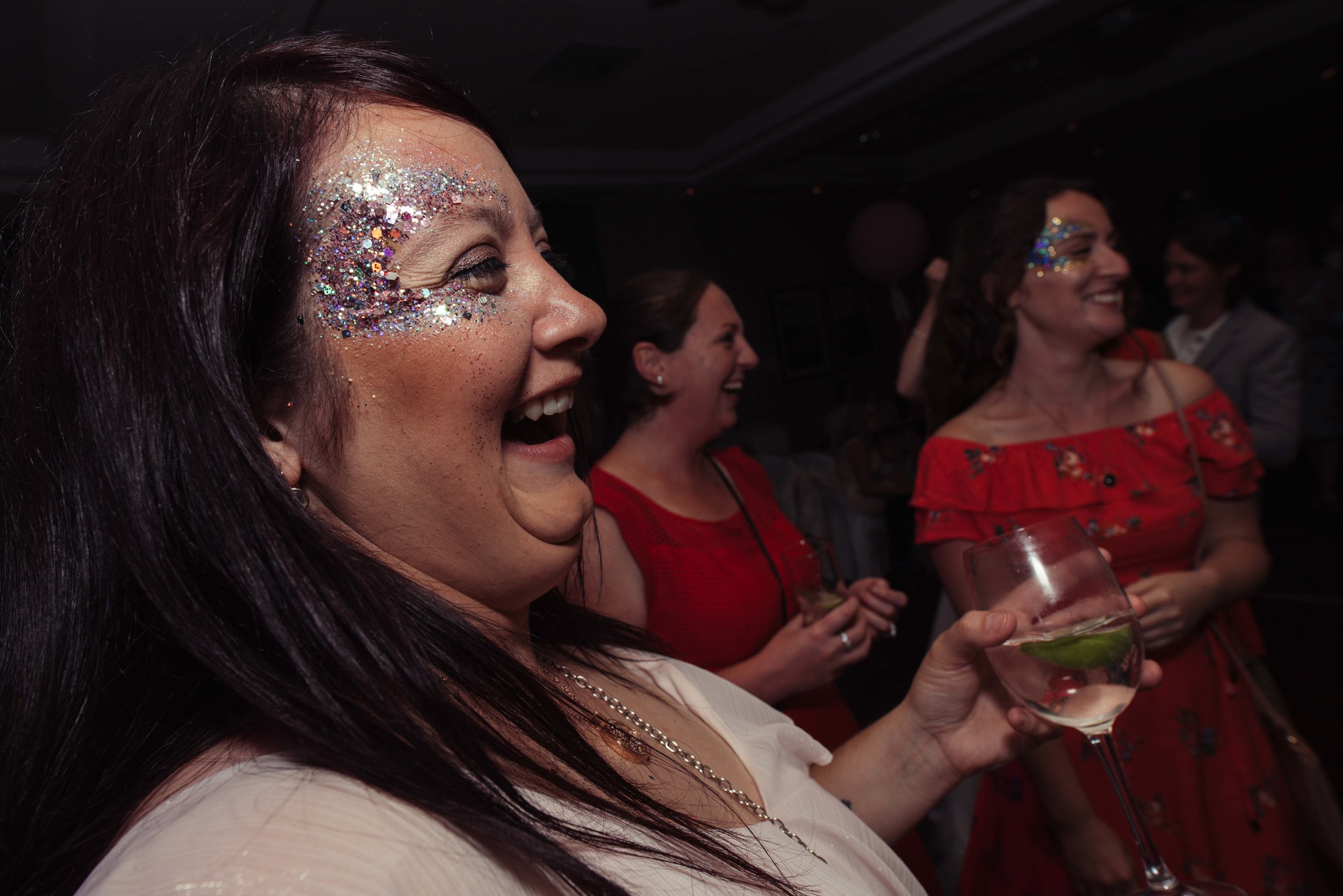 A very sparkly-faced wedding guest on the dance floor