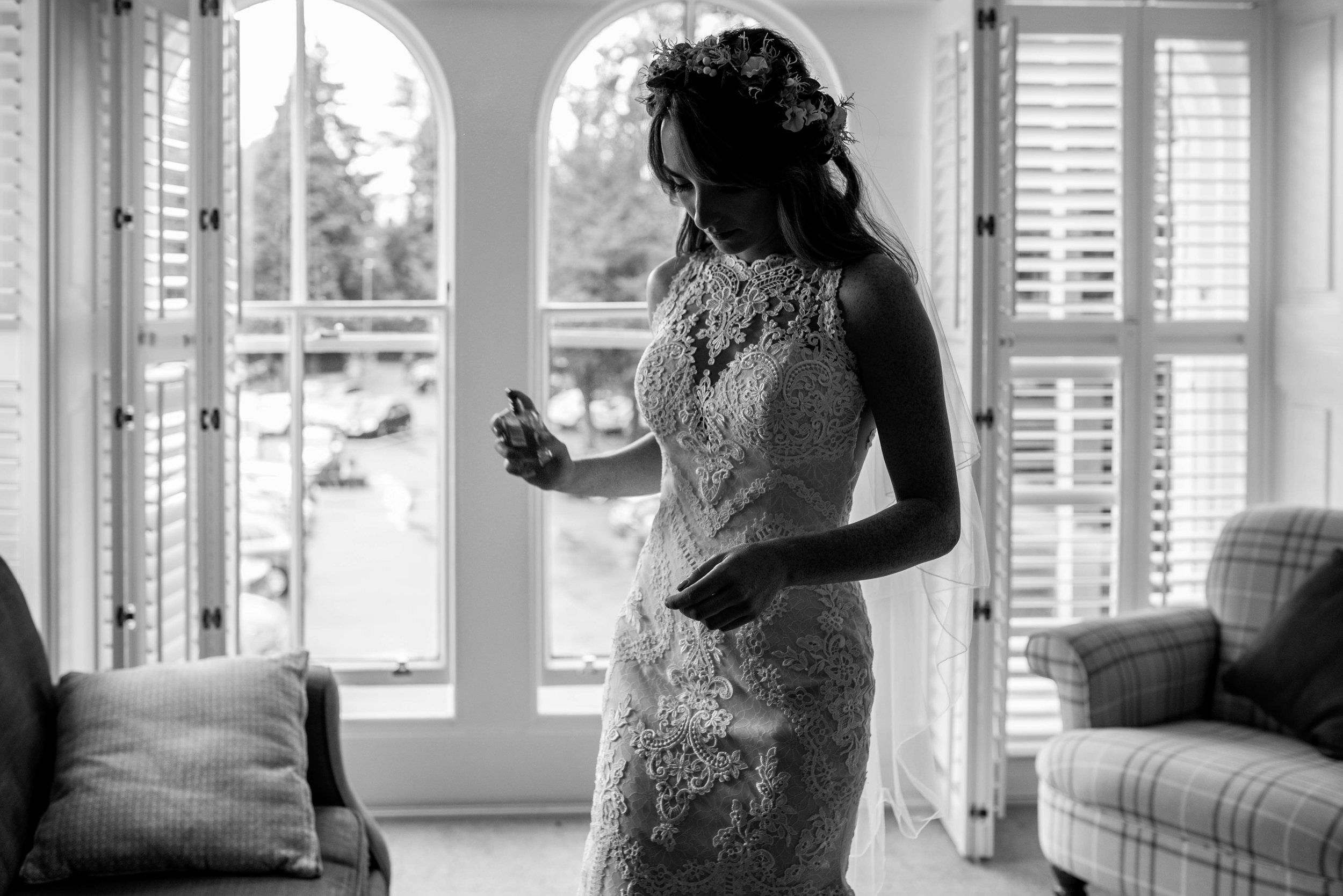 The bride applies perfume before heading down for her Cumbrian wedding
