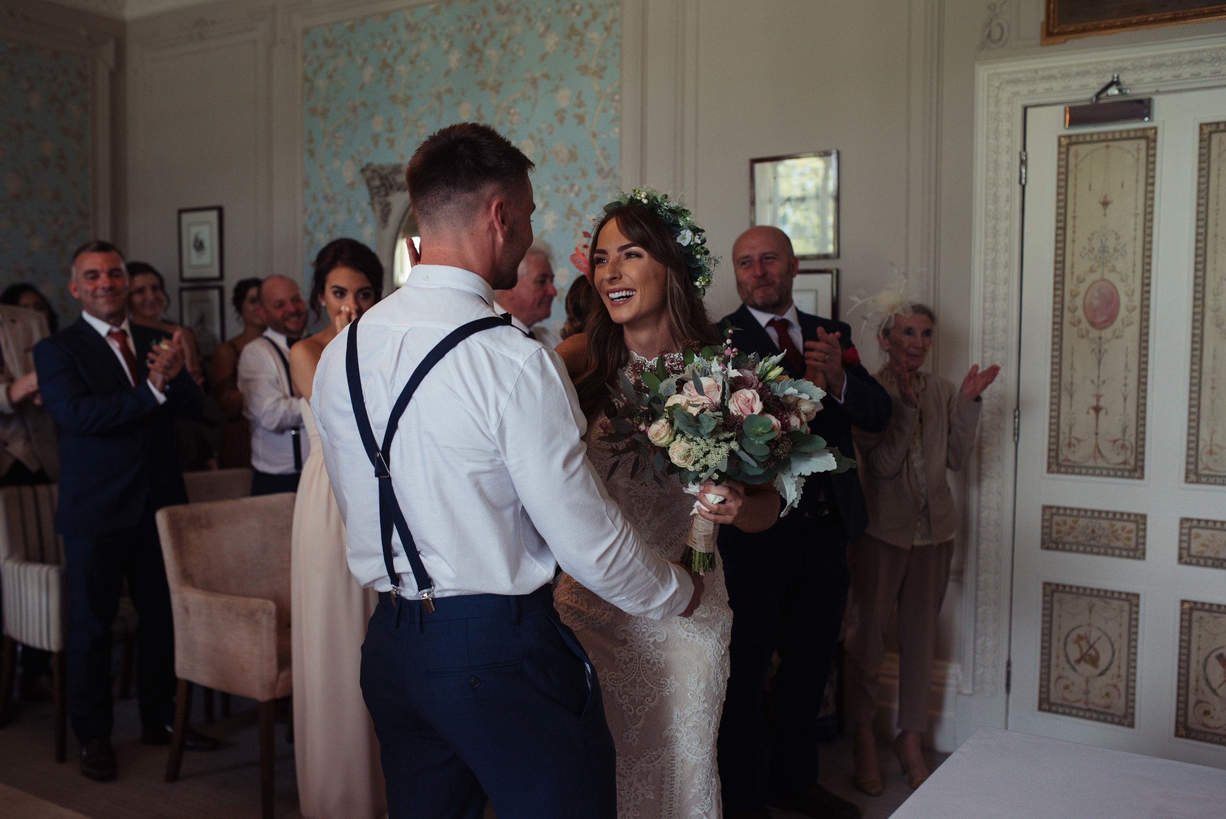 The bride and groom exchange their rings in their cumbria wedding