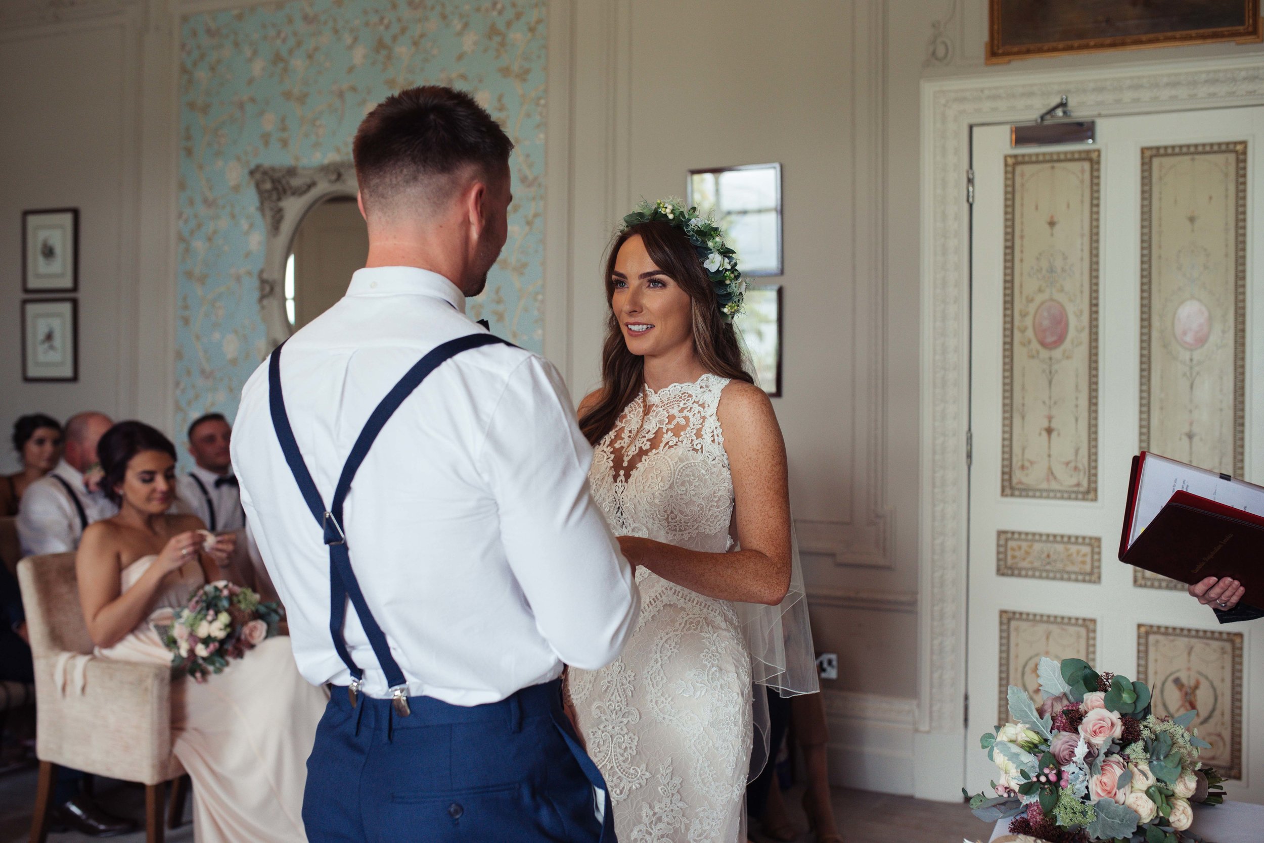 The bride and groom stand and make their wedding vows to each other