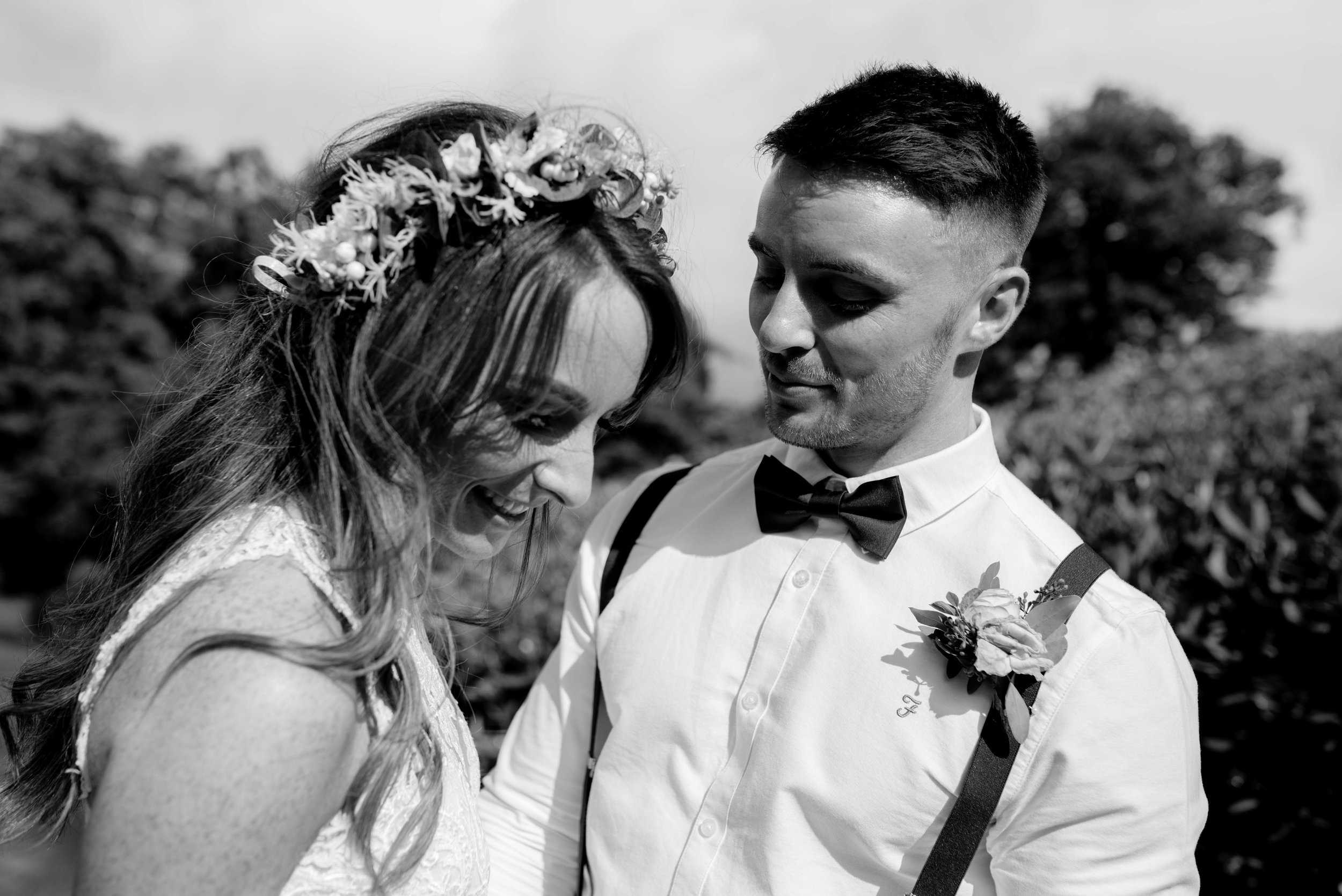 A natural cheeky moment for the bride and groom during their lake district photography portrait session