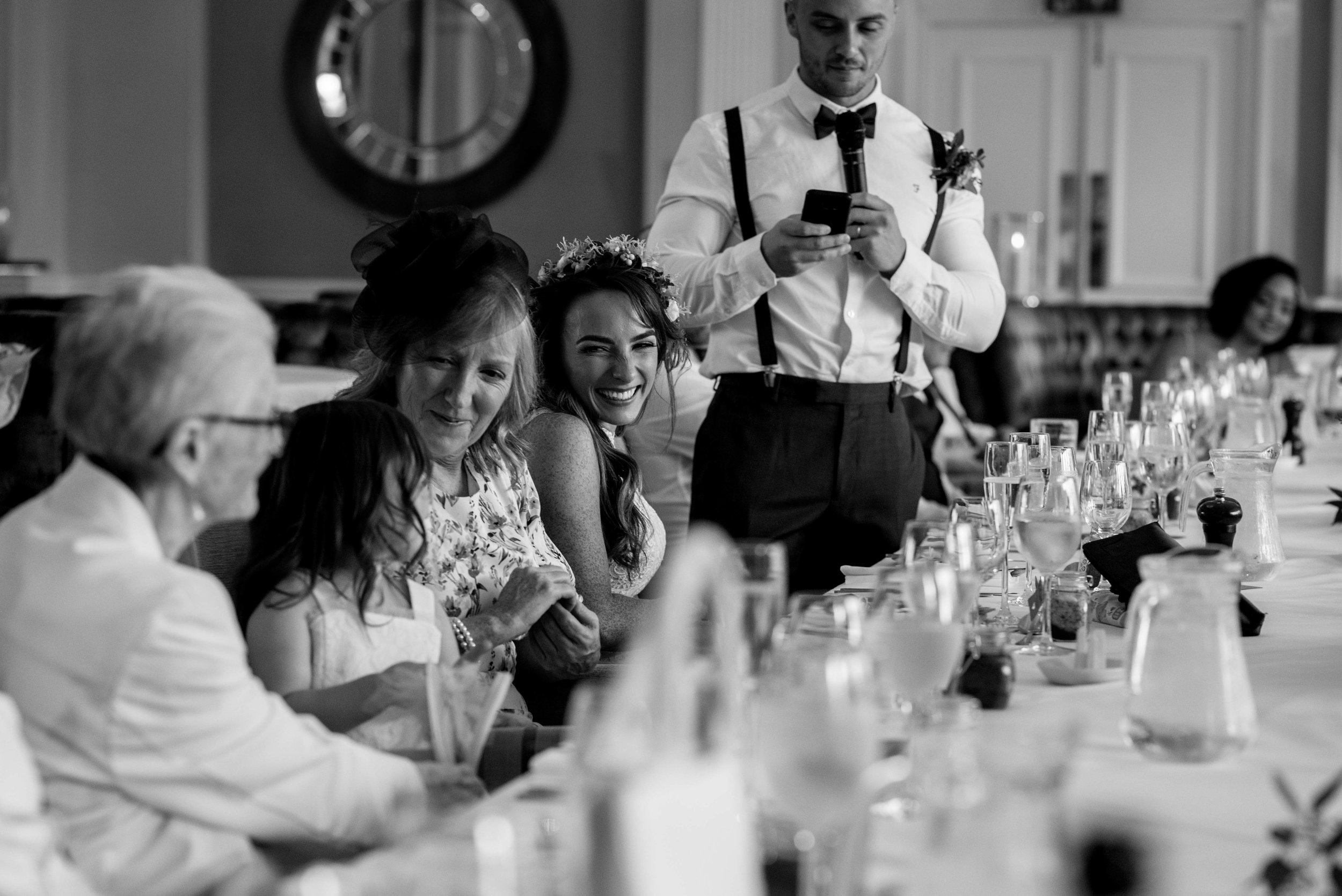 The bride smiles at her daughter as she is mentioned during the speeches