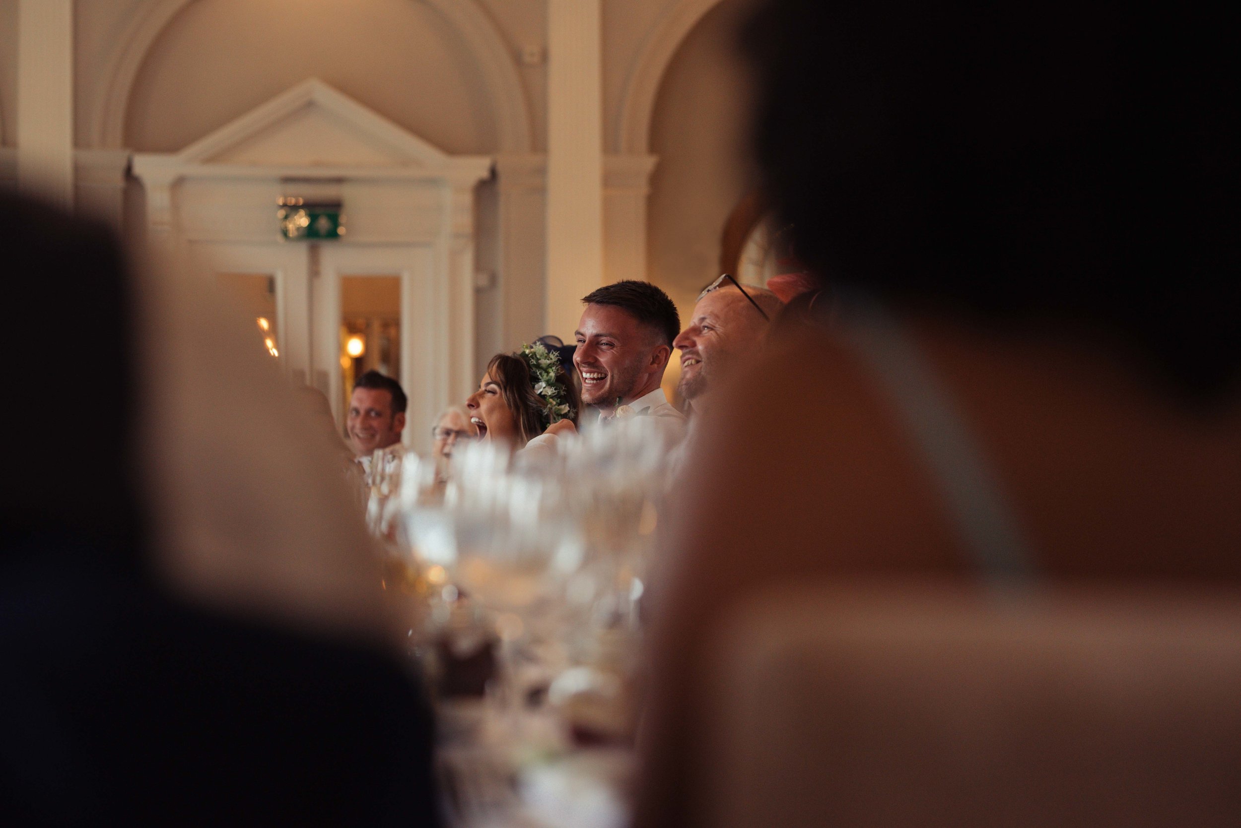 The groom laughs out loud during the best man speech