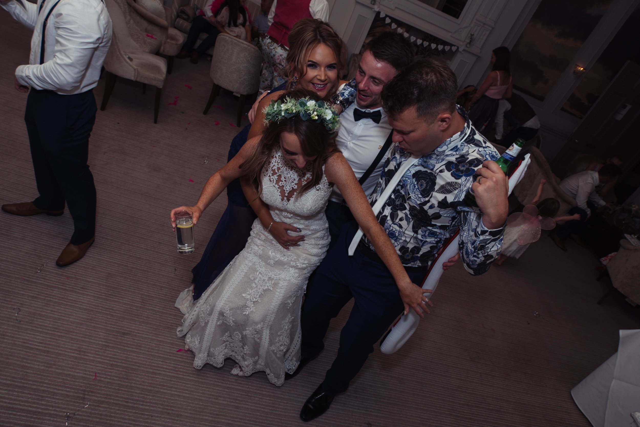 The bride dances with her friends