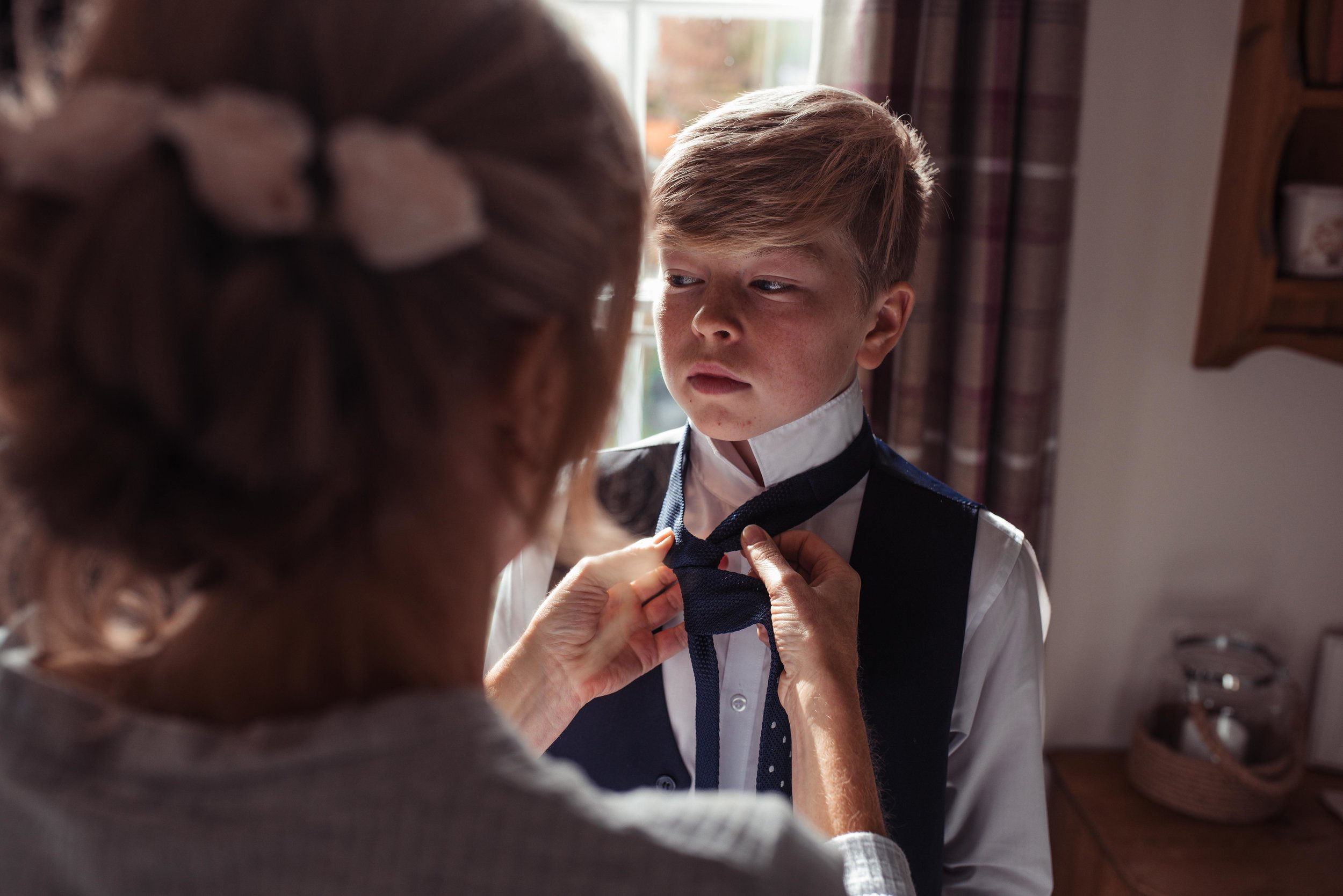The bride helping put on her sons tie