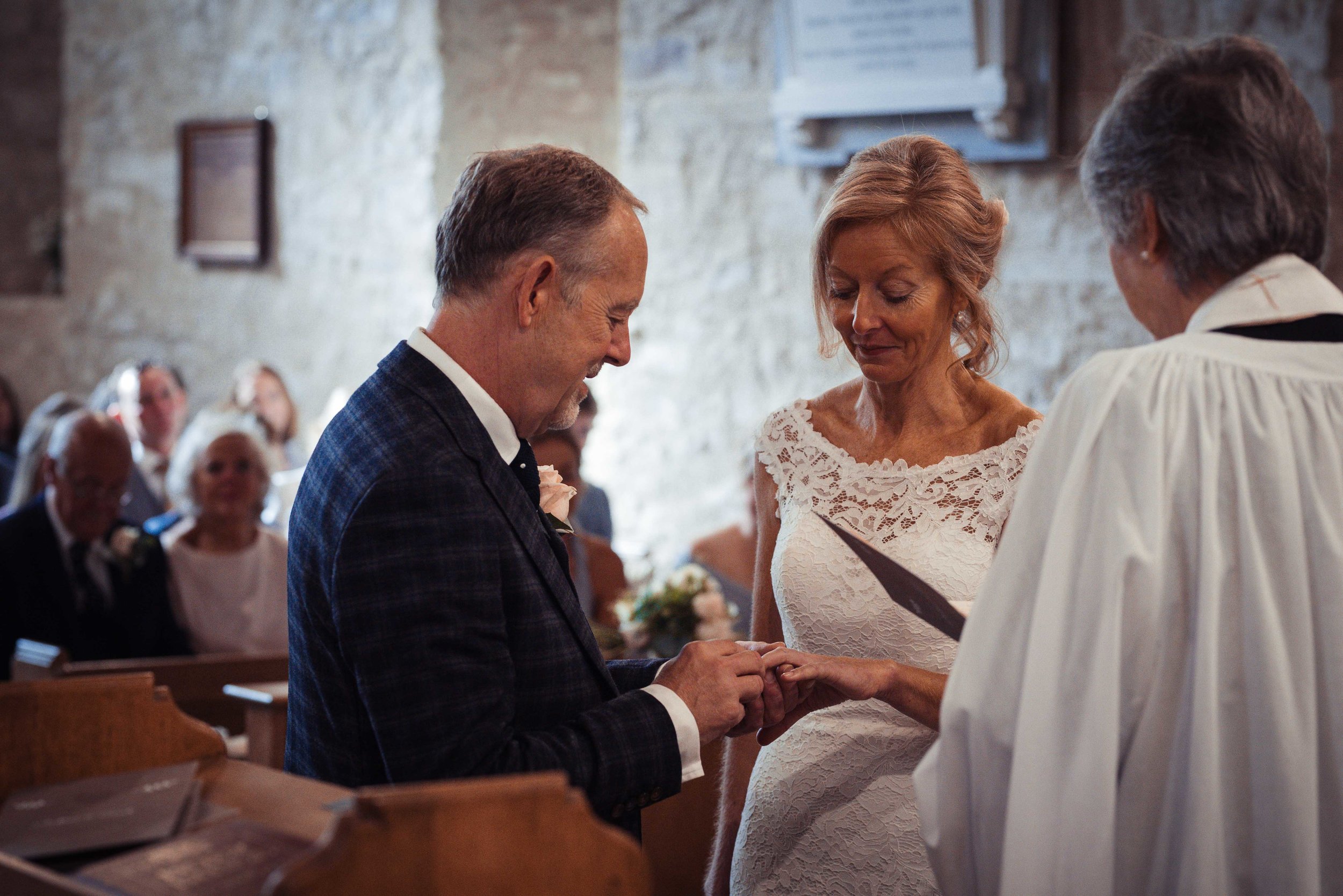 The bride and groom exchange rings during their lake district wedding
