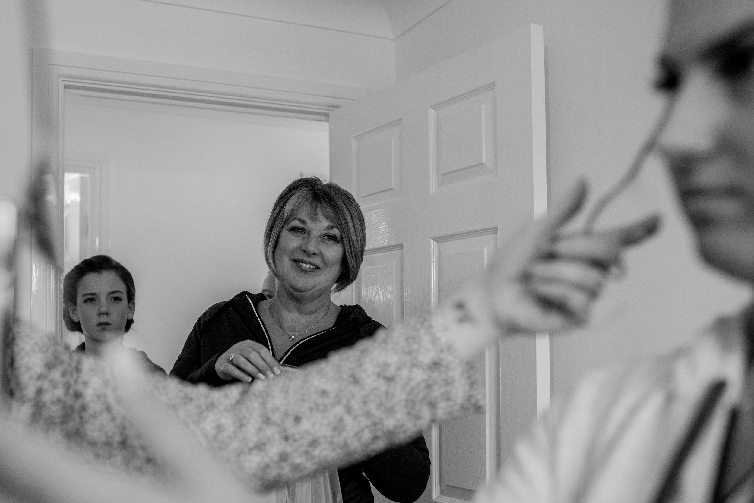 Proud mother of the bride looks at her daughter over her arm
