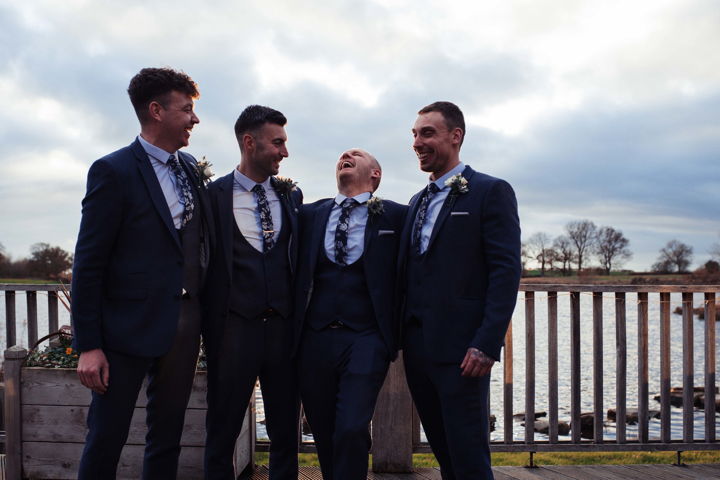 The groom and his ushers and best man pose for a photo