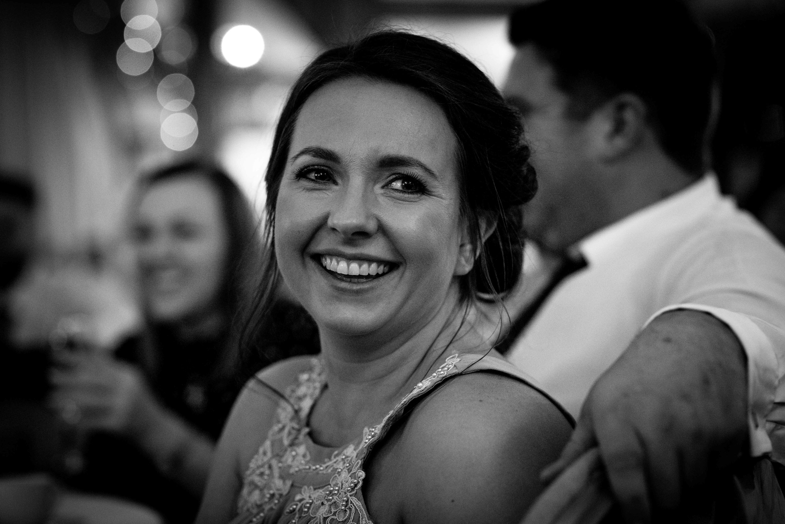 Close up of a bridesmaid laughing during the speeches