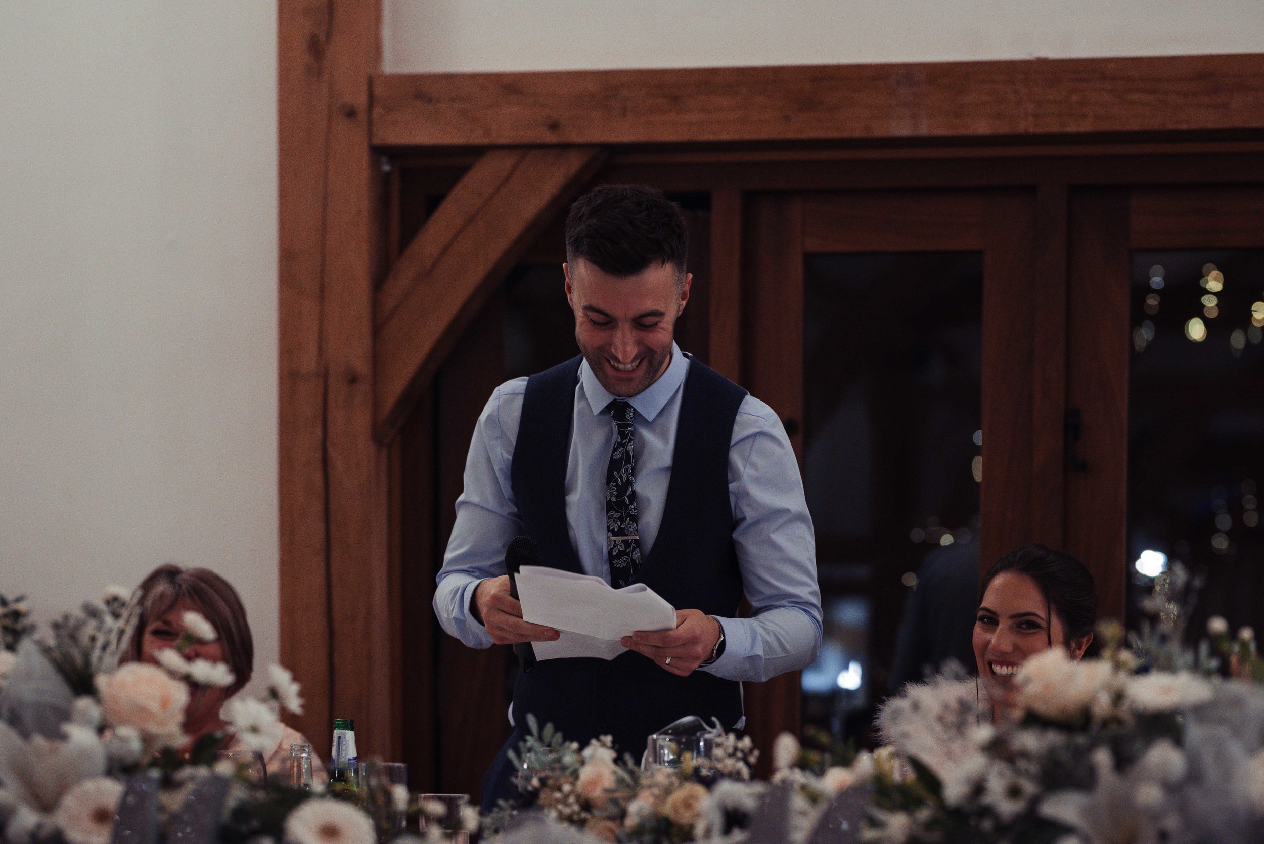 The groom delivers his speech in the barn