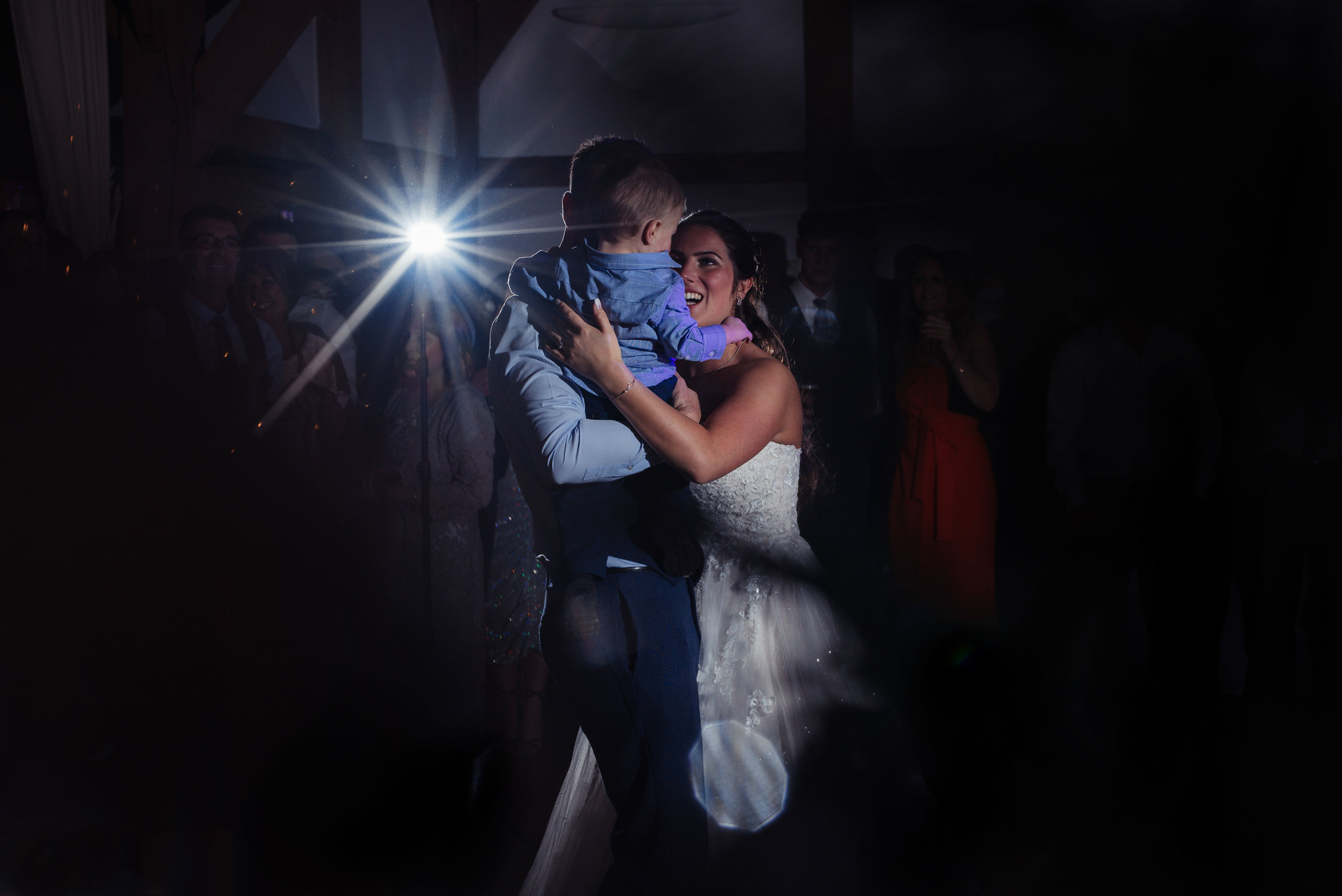 The bride and groom on the dancefloor with their son