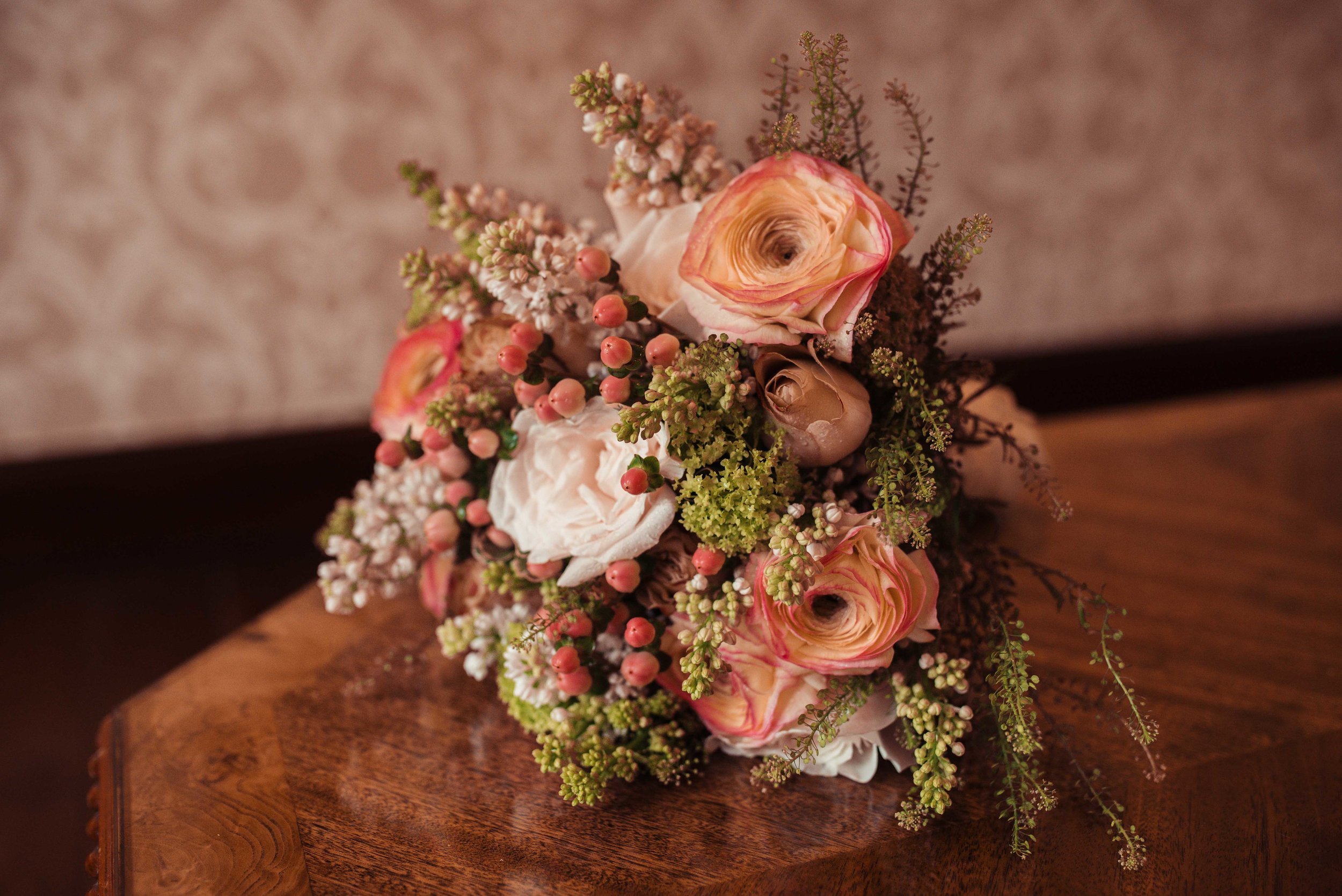 Dusky pink and peach bridal flowers on a table at Holbeck Ghyll