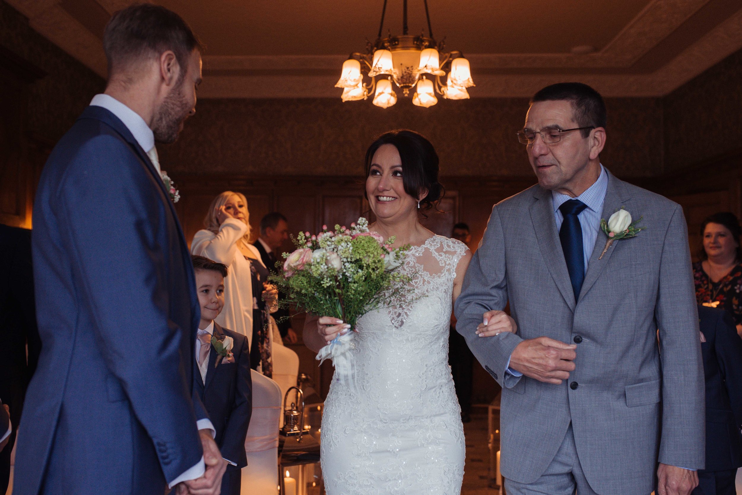 The bride and her father enter the wedding ceremony