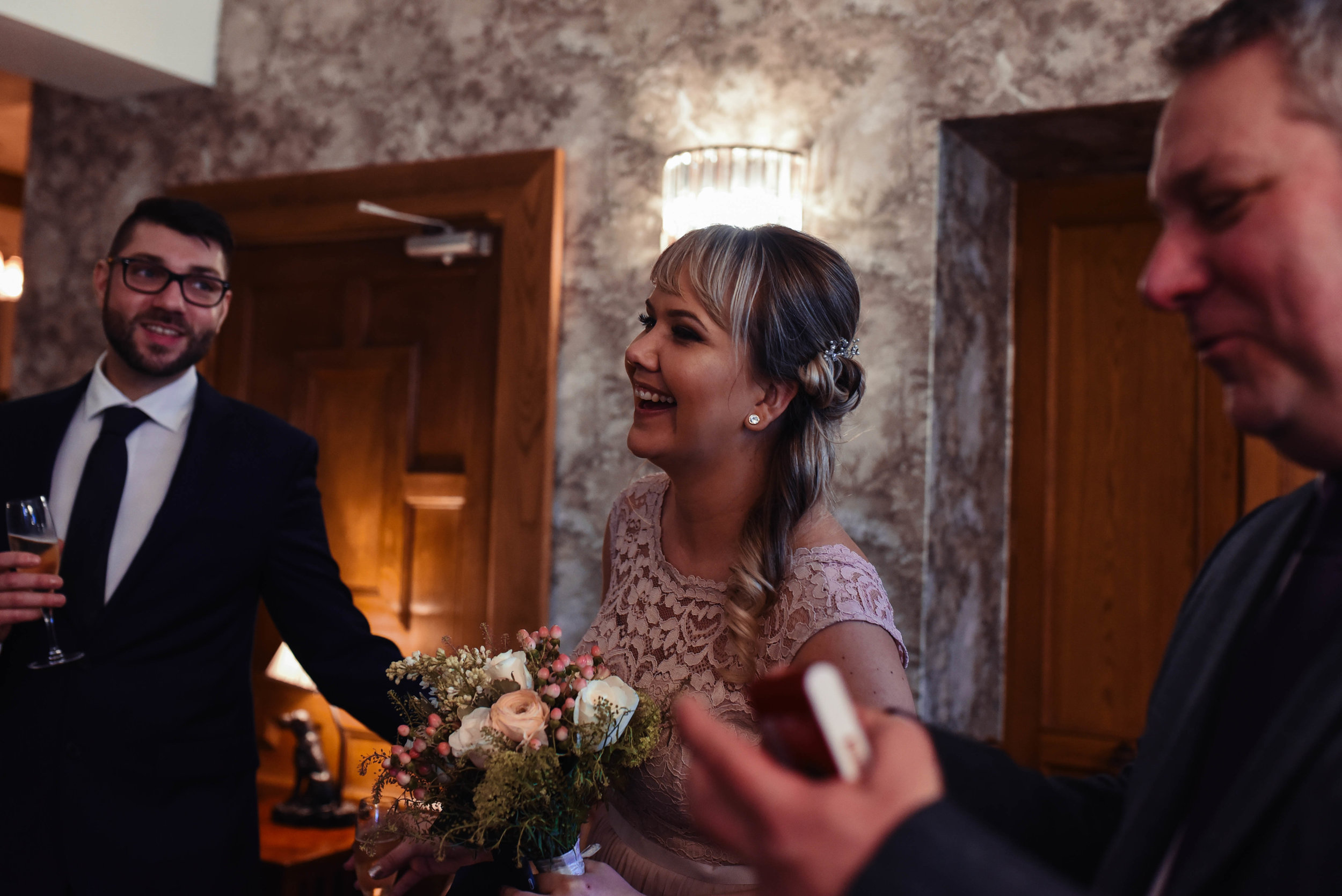 Bridesmaid laughing during the drinks reception