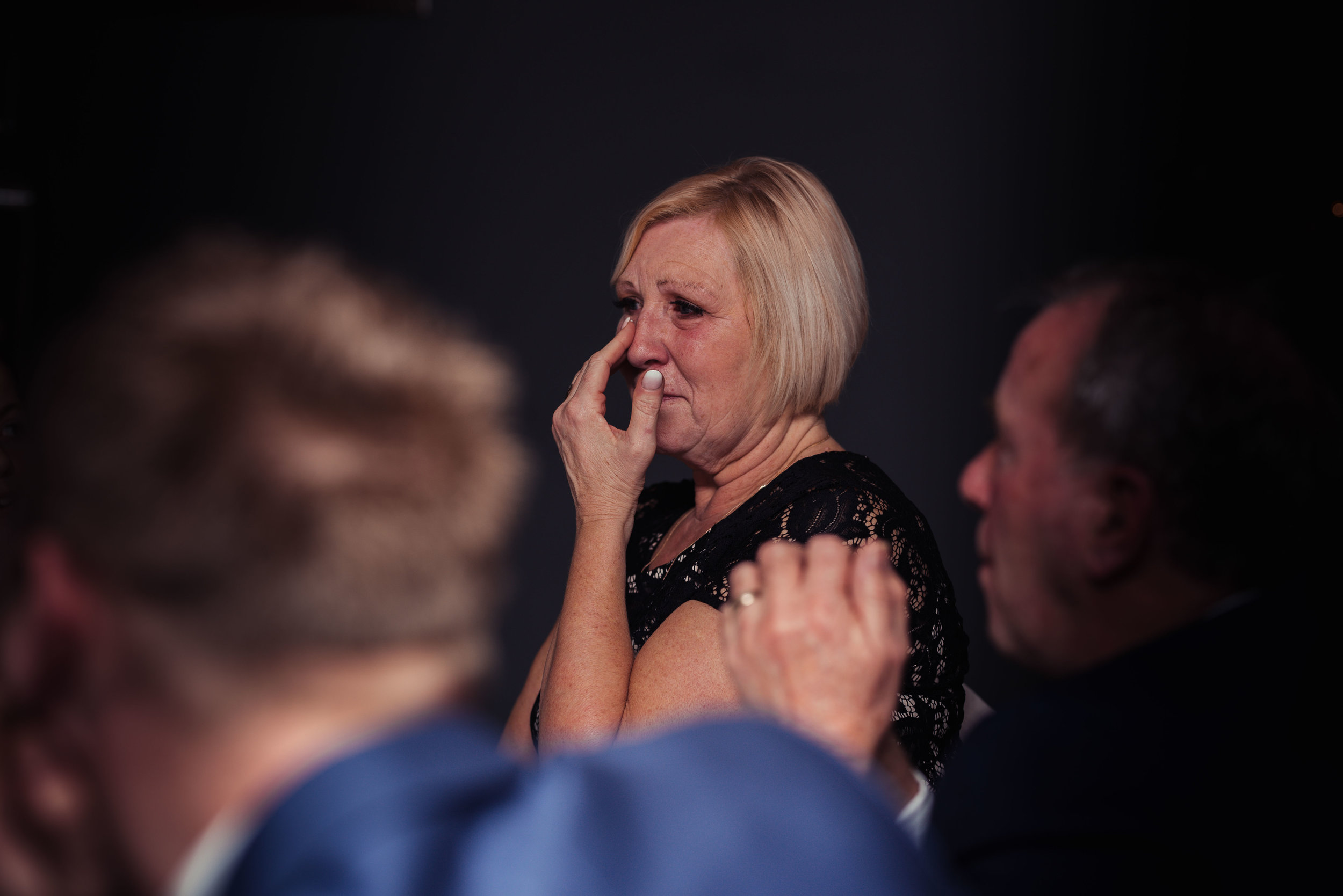 Mother of the groom laughing out loud during her sons speech