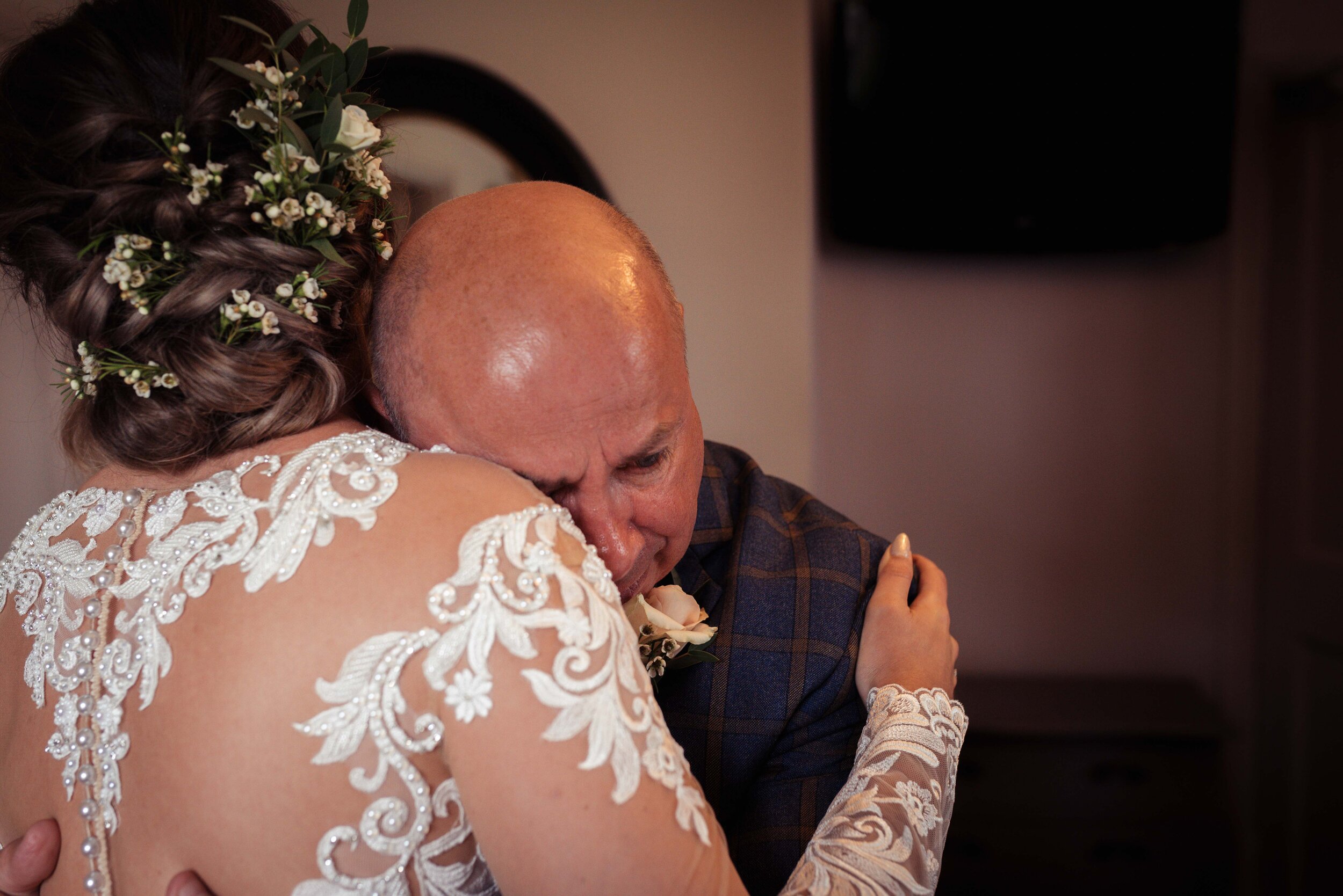 Father of the bride gives his daughter a cuddle