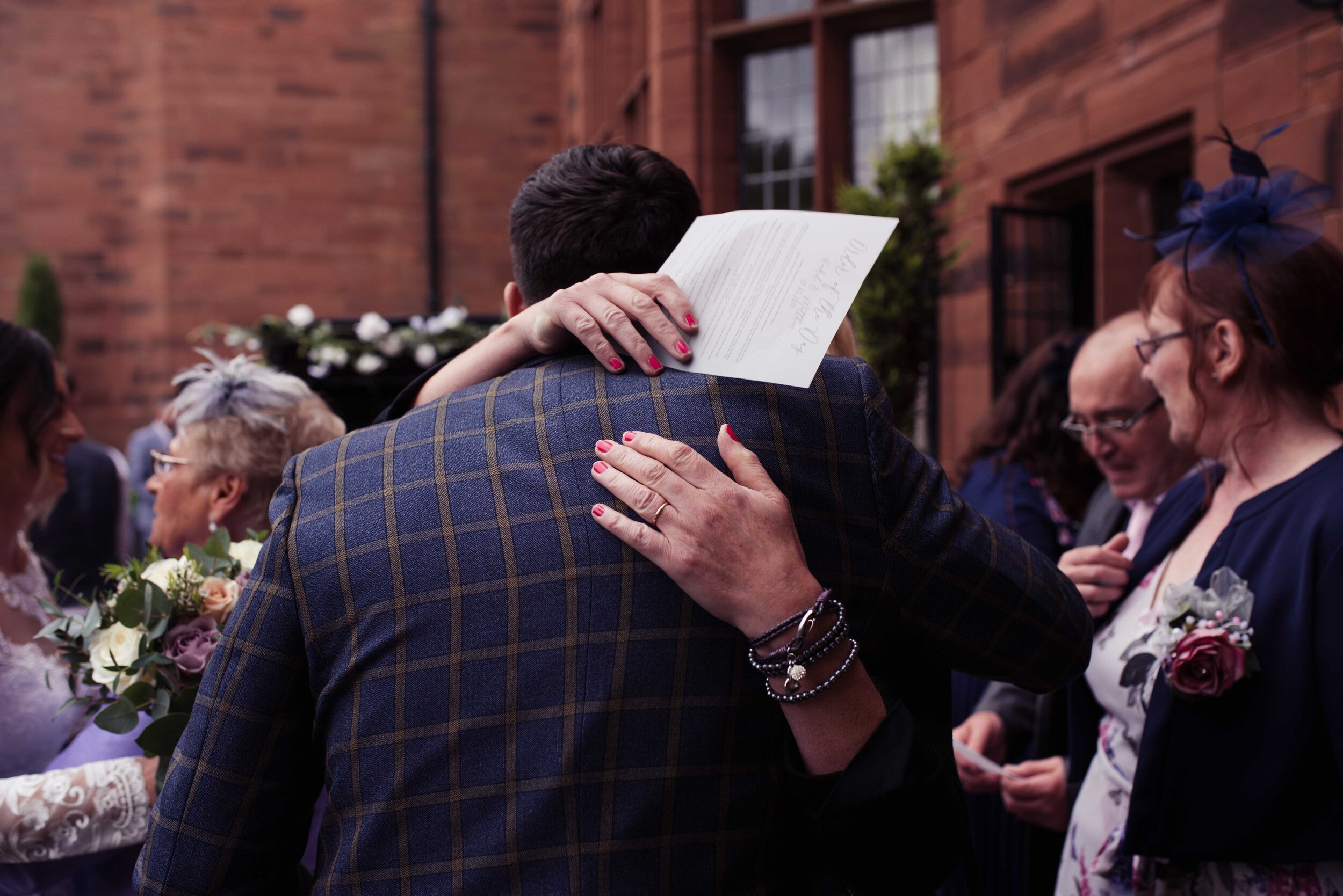 Big cuddles for the groom after the wedding