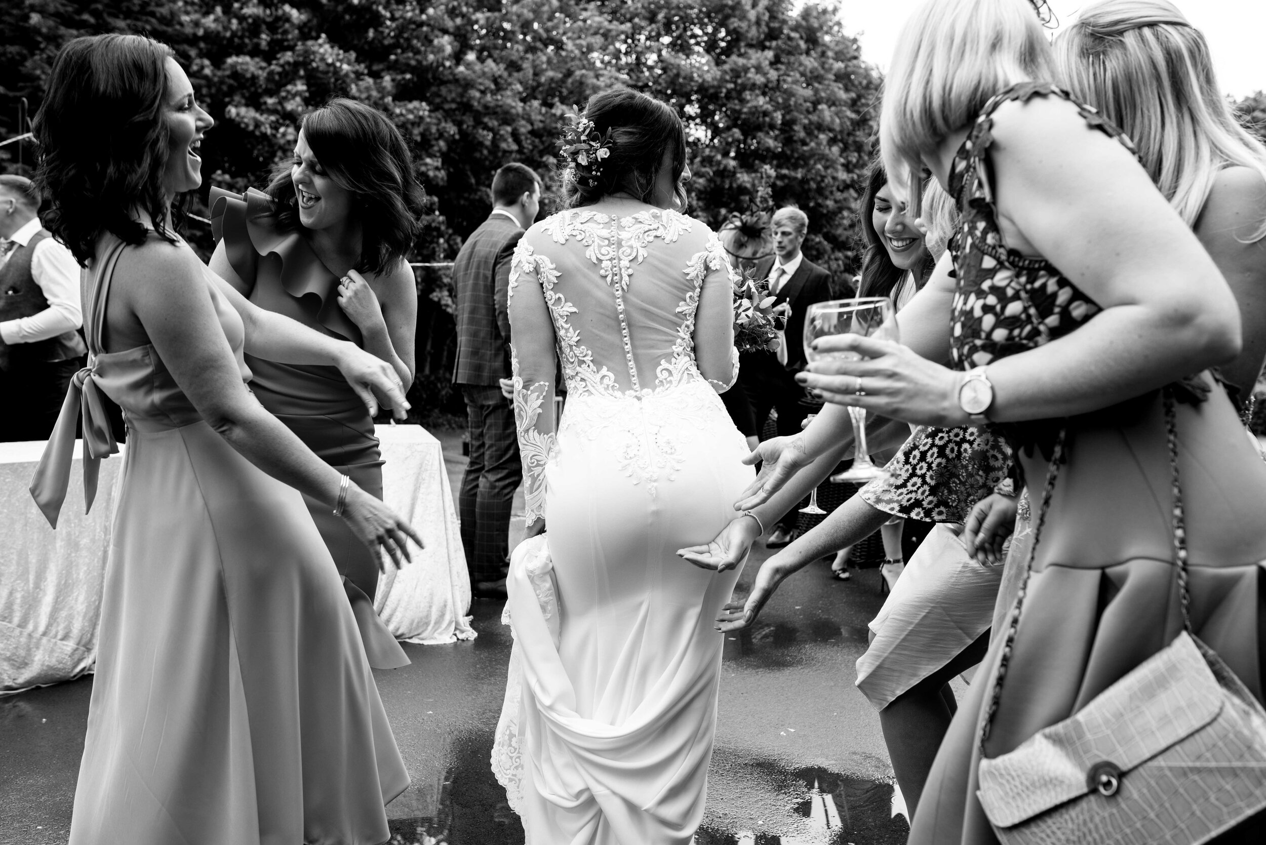 Wedding guests admire the brides dress