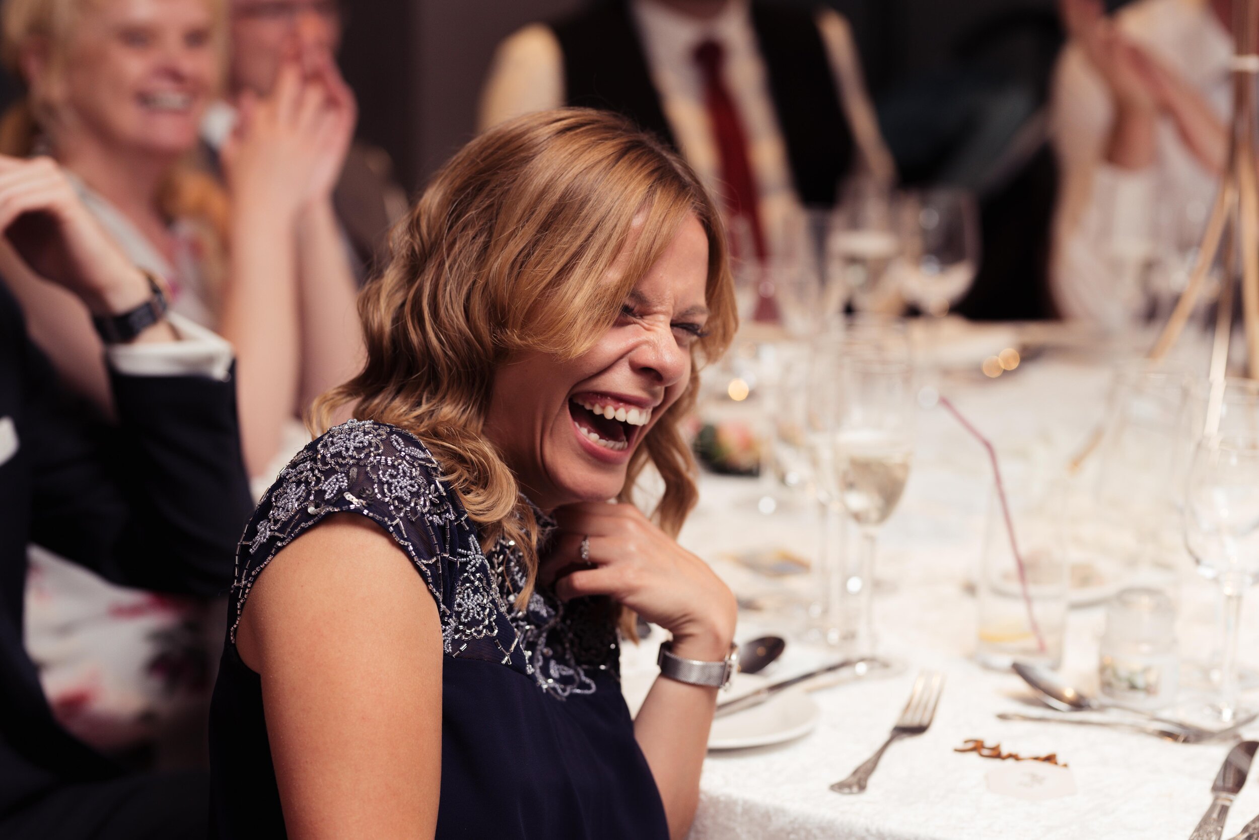 Wedding guest laughs out loud during the speeches